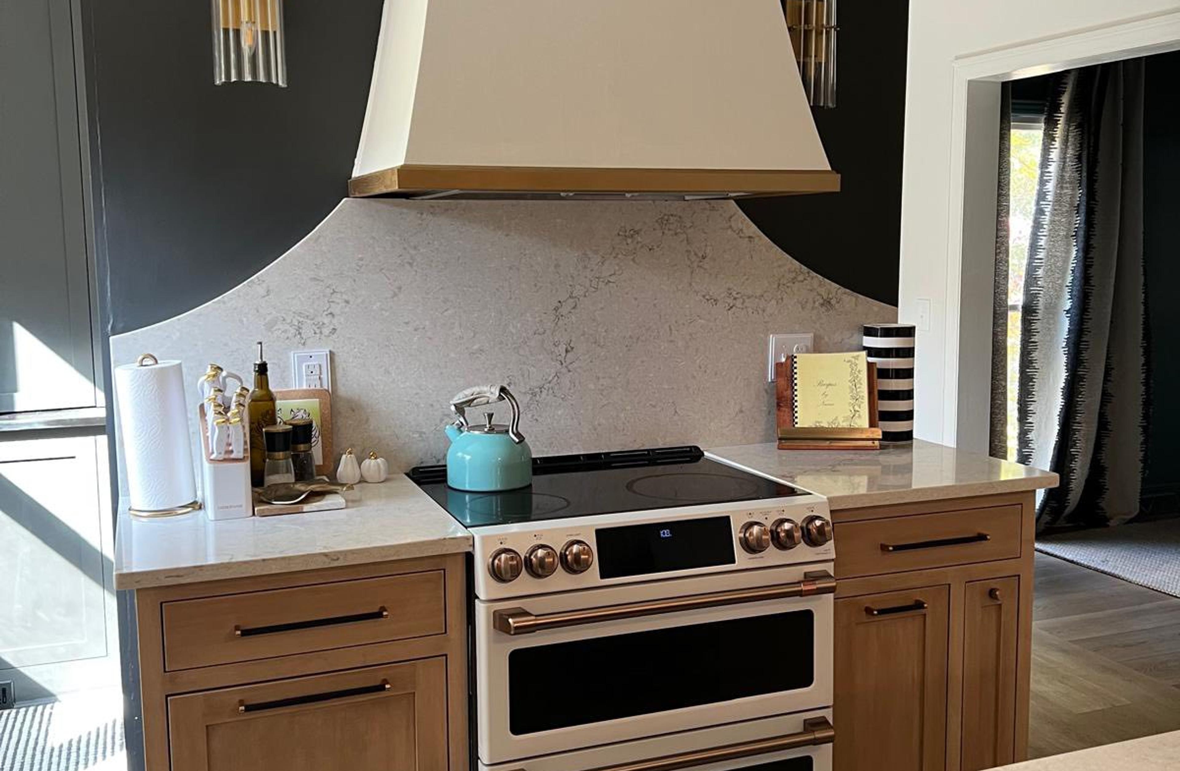 Two-tone kitchen with custom cream hood and green island