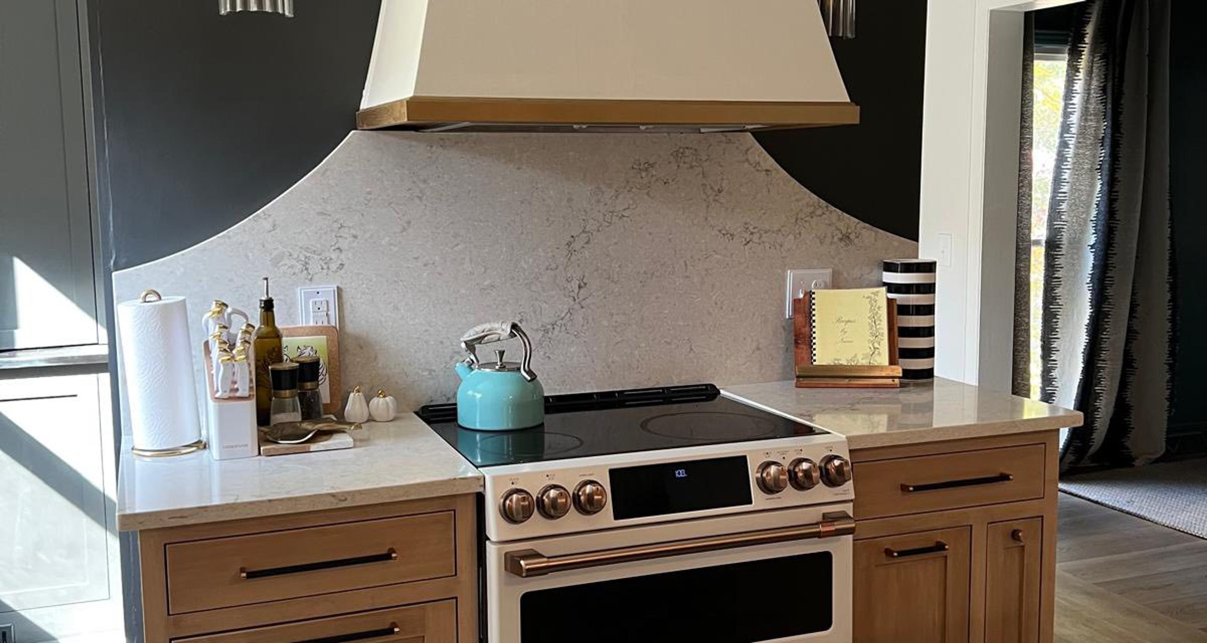 Two-tone kitchen with custom cream hood and green island