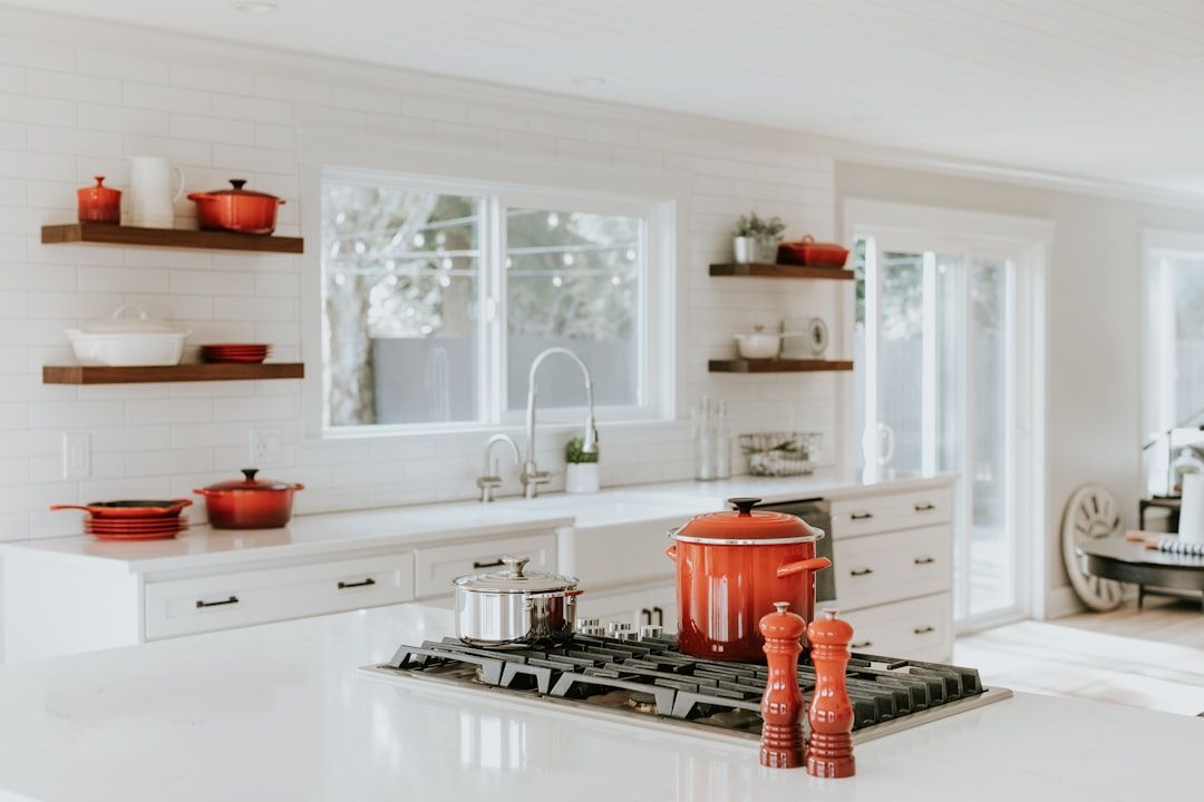 Open shelving with styled cookware in a white kitchen