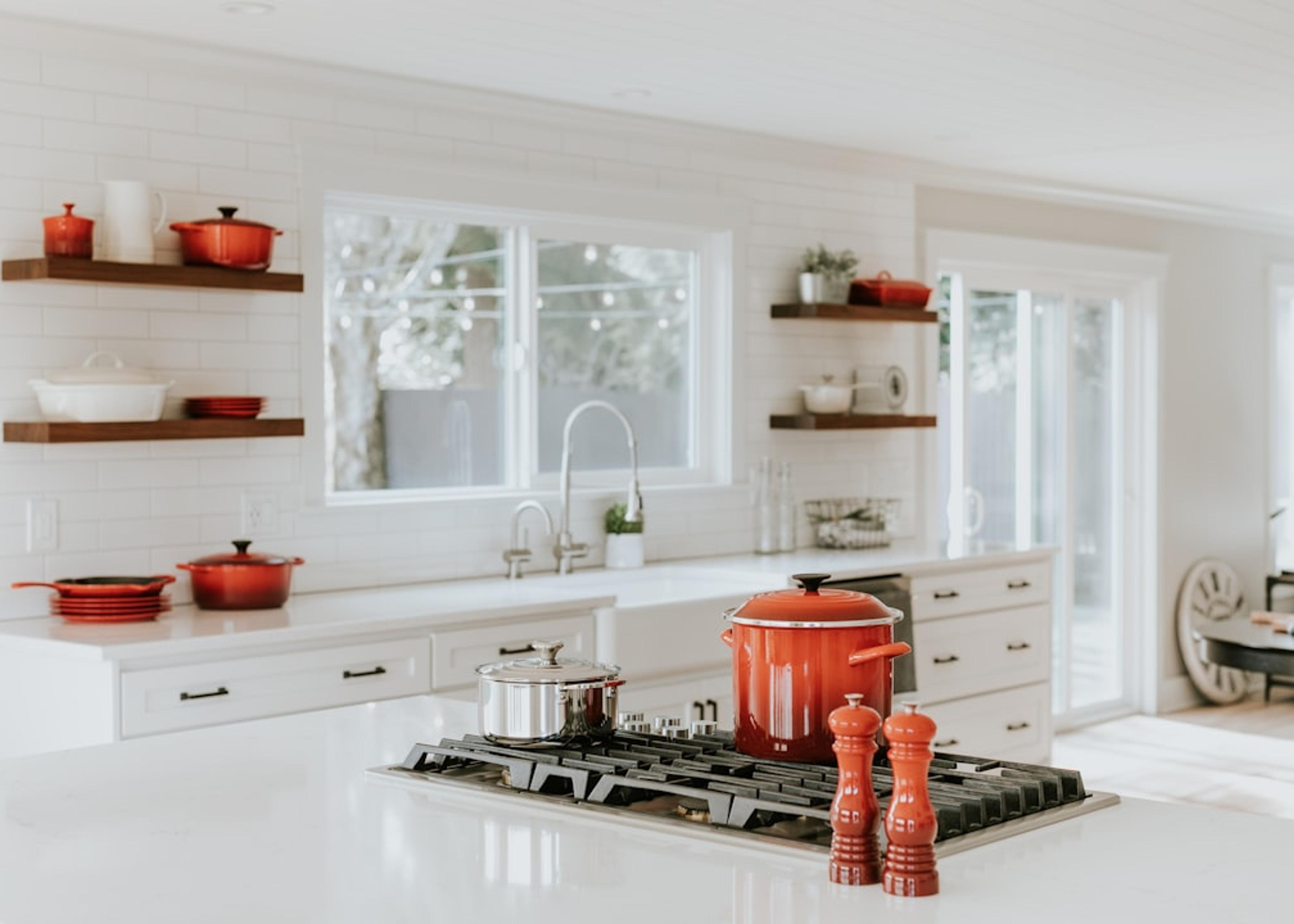 Kitchen finishes and open shelving styled with cookware