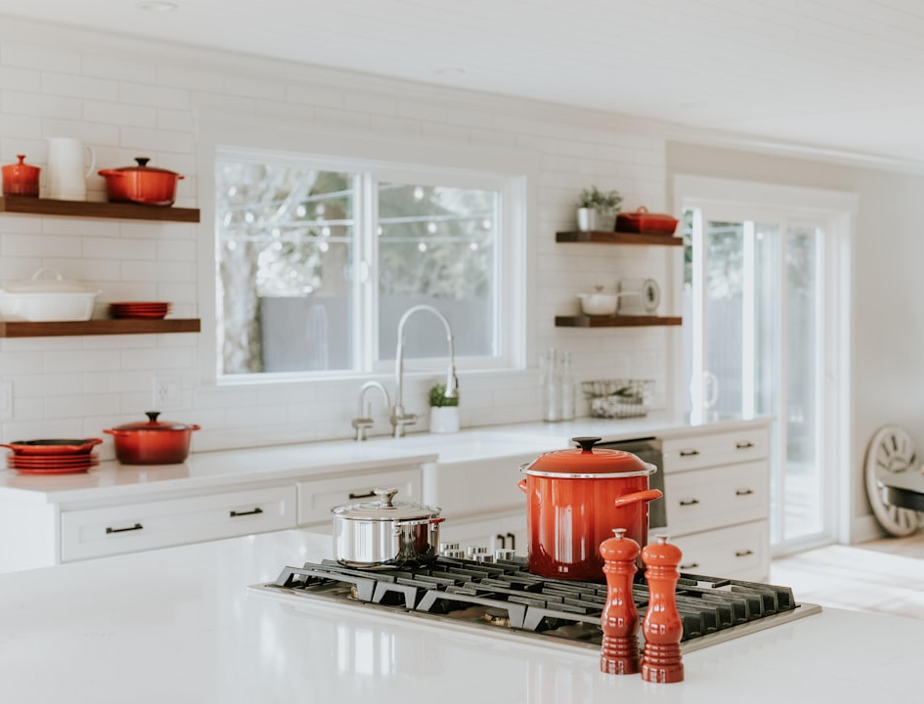 White kitchen with open shelving styled with copper cookware