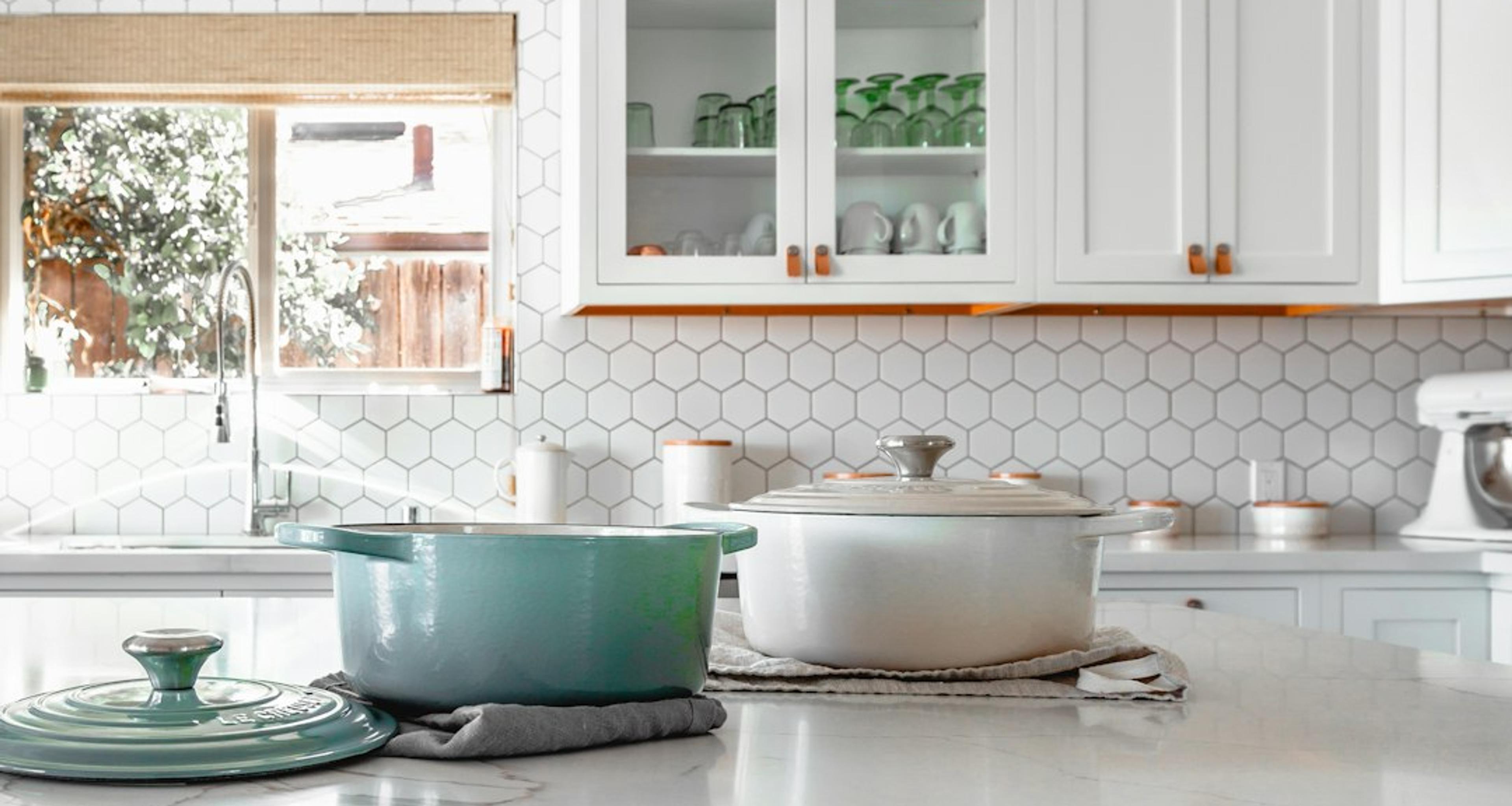 Compact white kitchen with glass-front cabinet