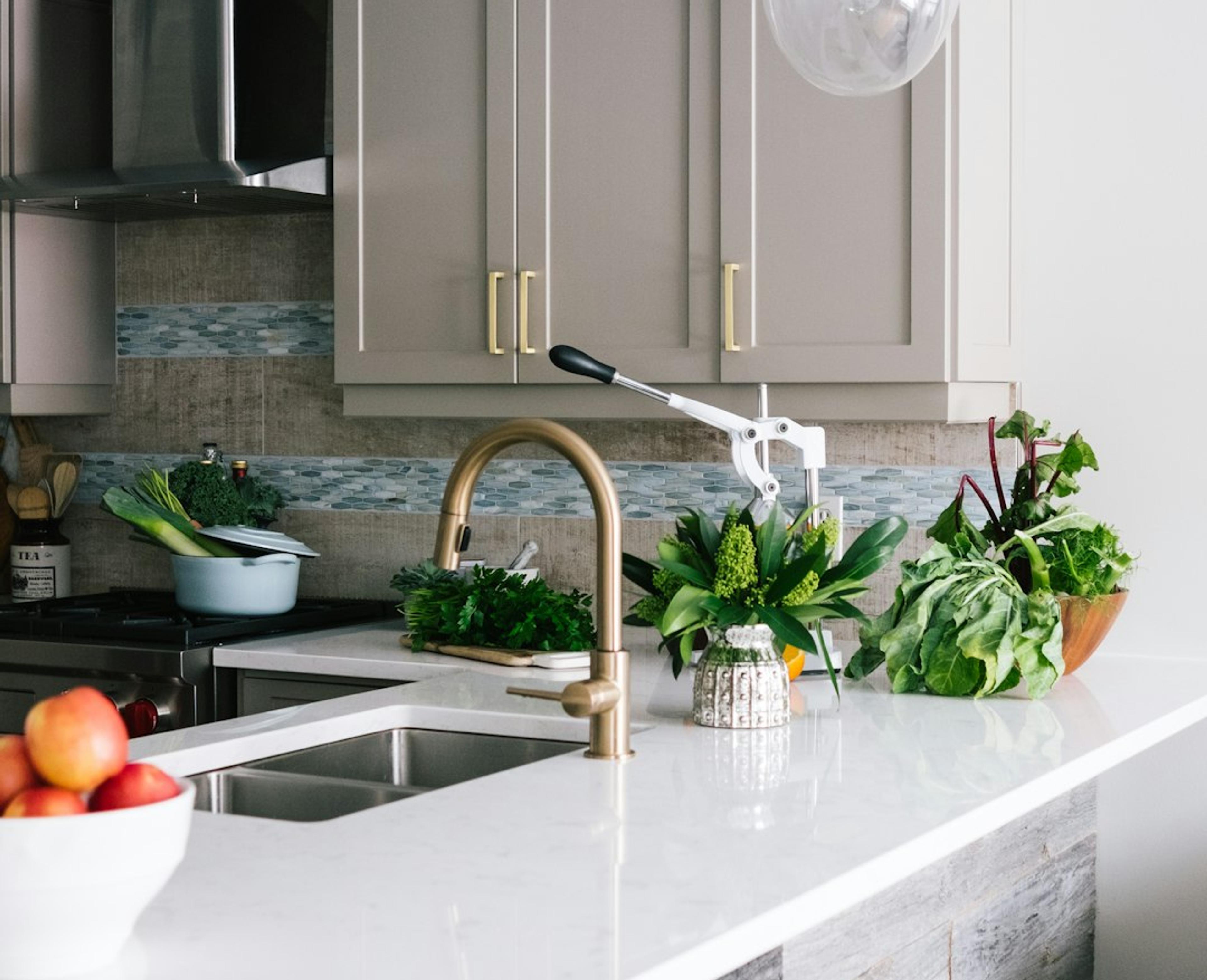 Greige shaker kitchen with brass accents