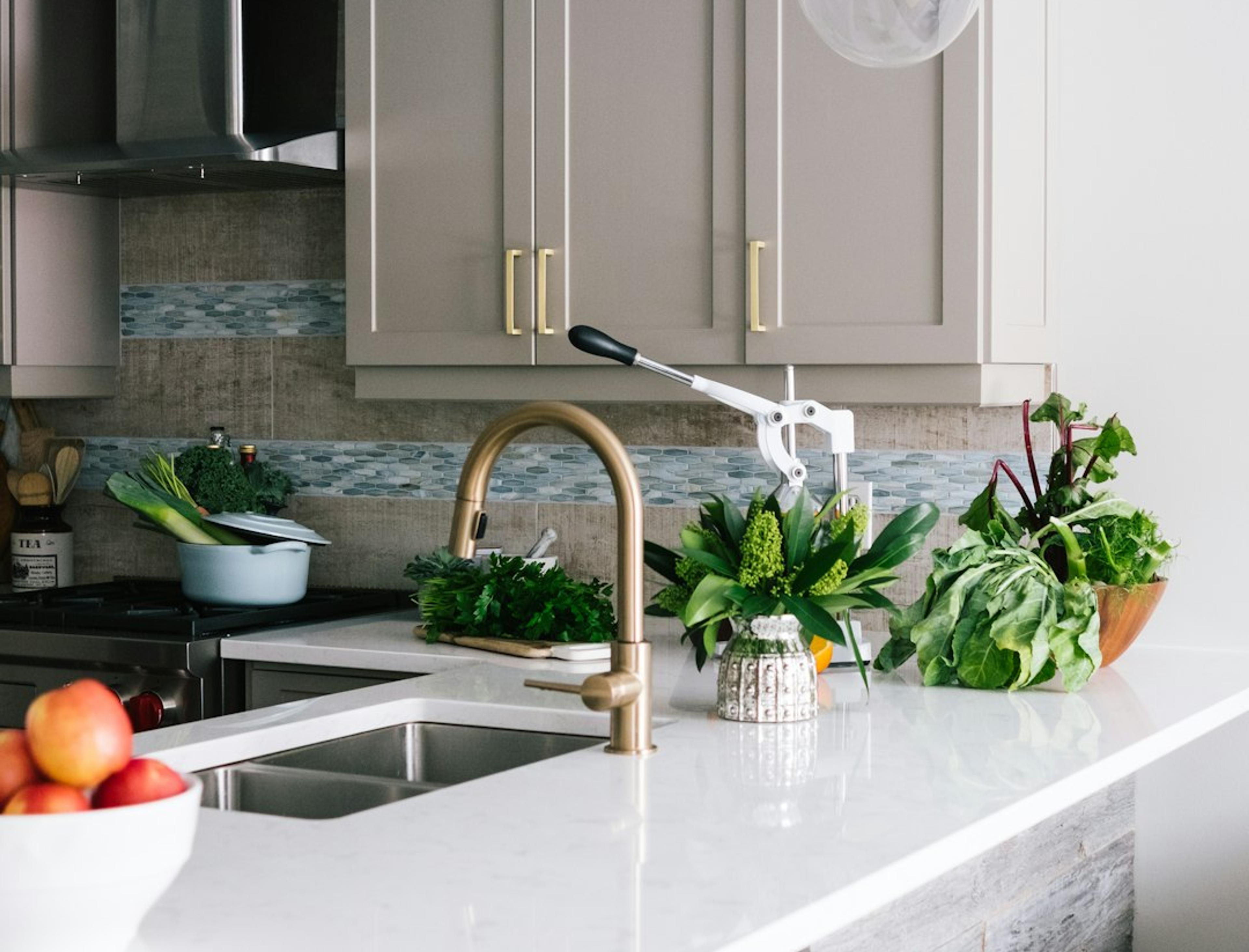 Greige shaker kitchen island with quartz countertop and wood barstools