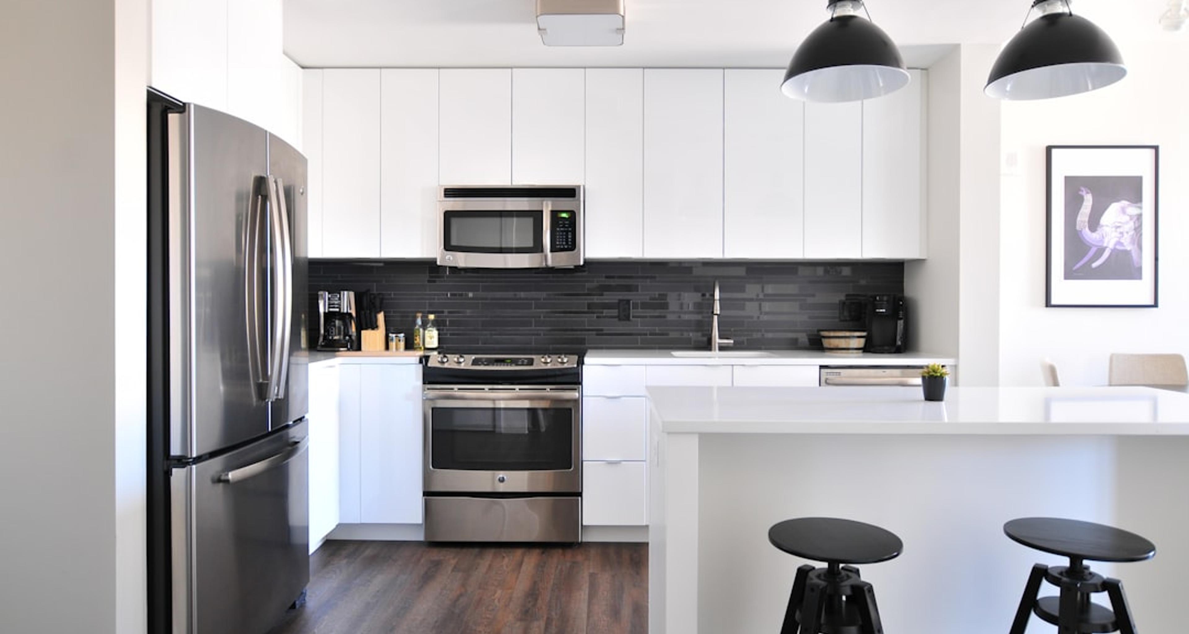 White kitchen with black accent wall
