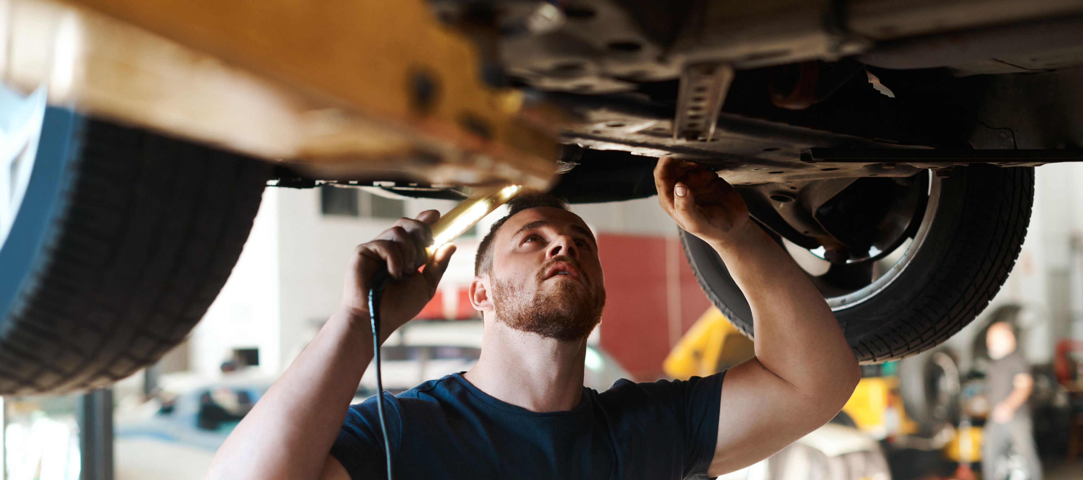 Mechanic working under car
