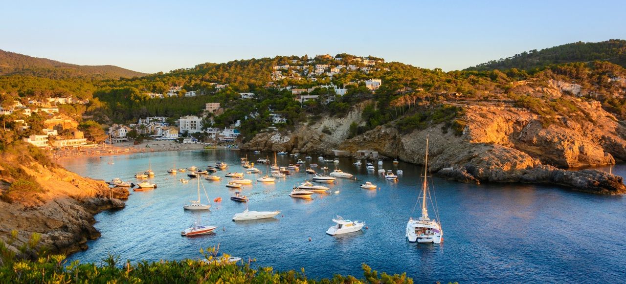 Sunset in the small bay of Cala Vedella, Ibiza island.
