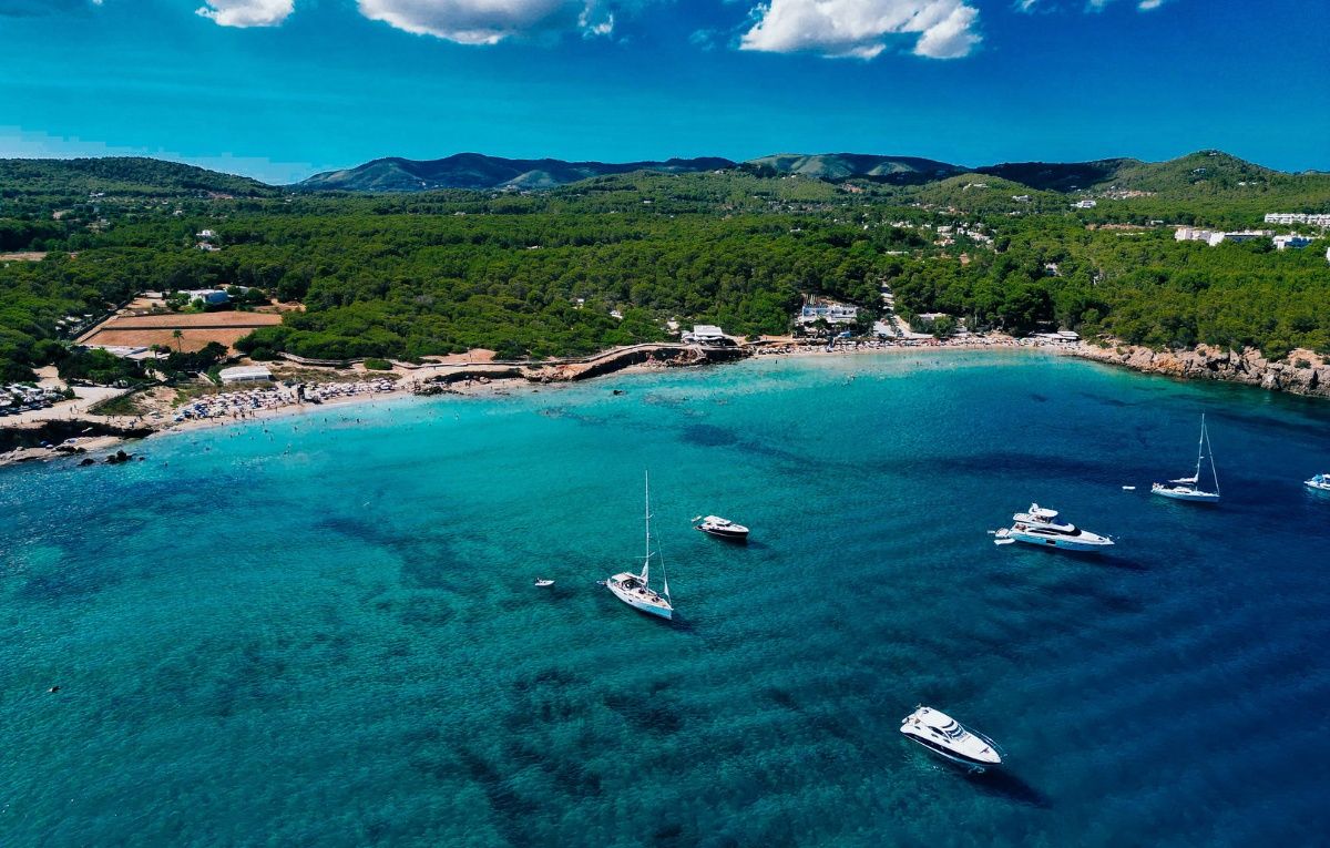 Aerial photo of coastline cala nova with sailing yachts blue sea. Ibiza, Balearic Island