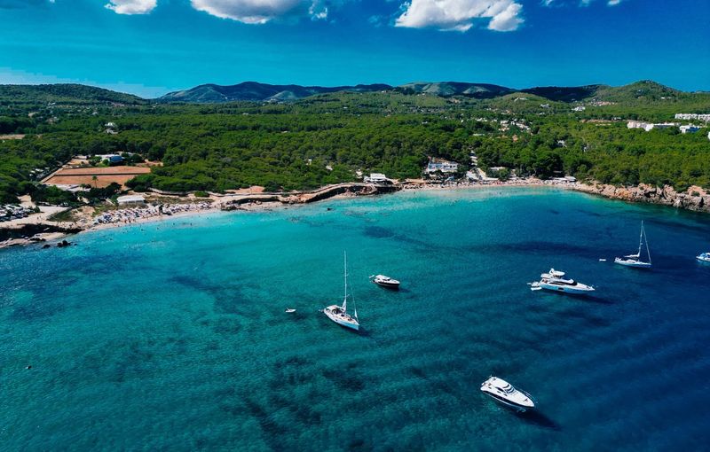 Aerial photo of coastline cala nova with sailing yachts blue sea. Ibiza, Balearic Island
