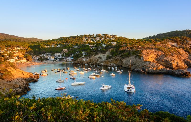 Sunset in the small bay of Cala Vedella, Ibiza island.