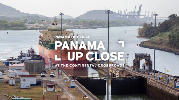 A cargo ship prepares to pass through the Panama Canal. The title "Panama Up Close" is overlaid on the image.