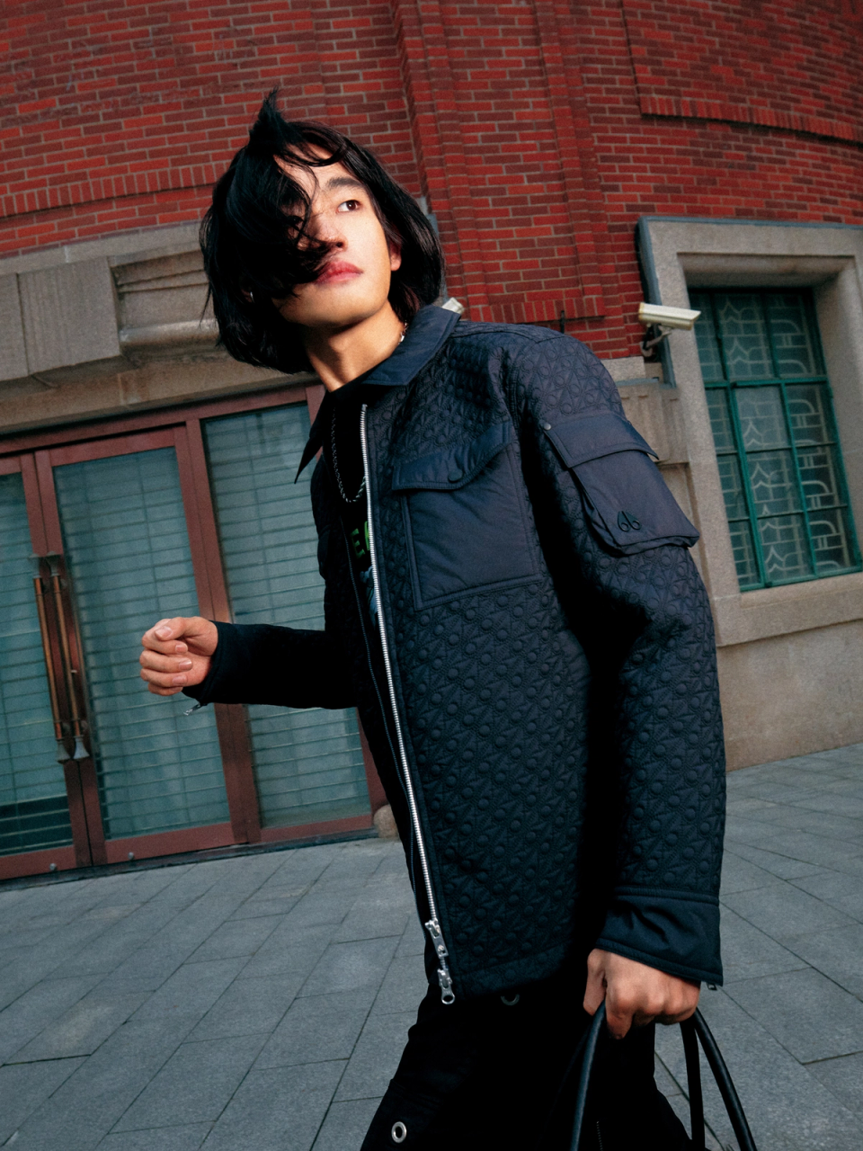 Model wearing black Moose Knuckles jacket on the streets