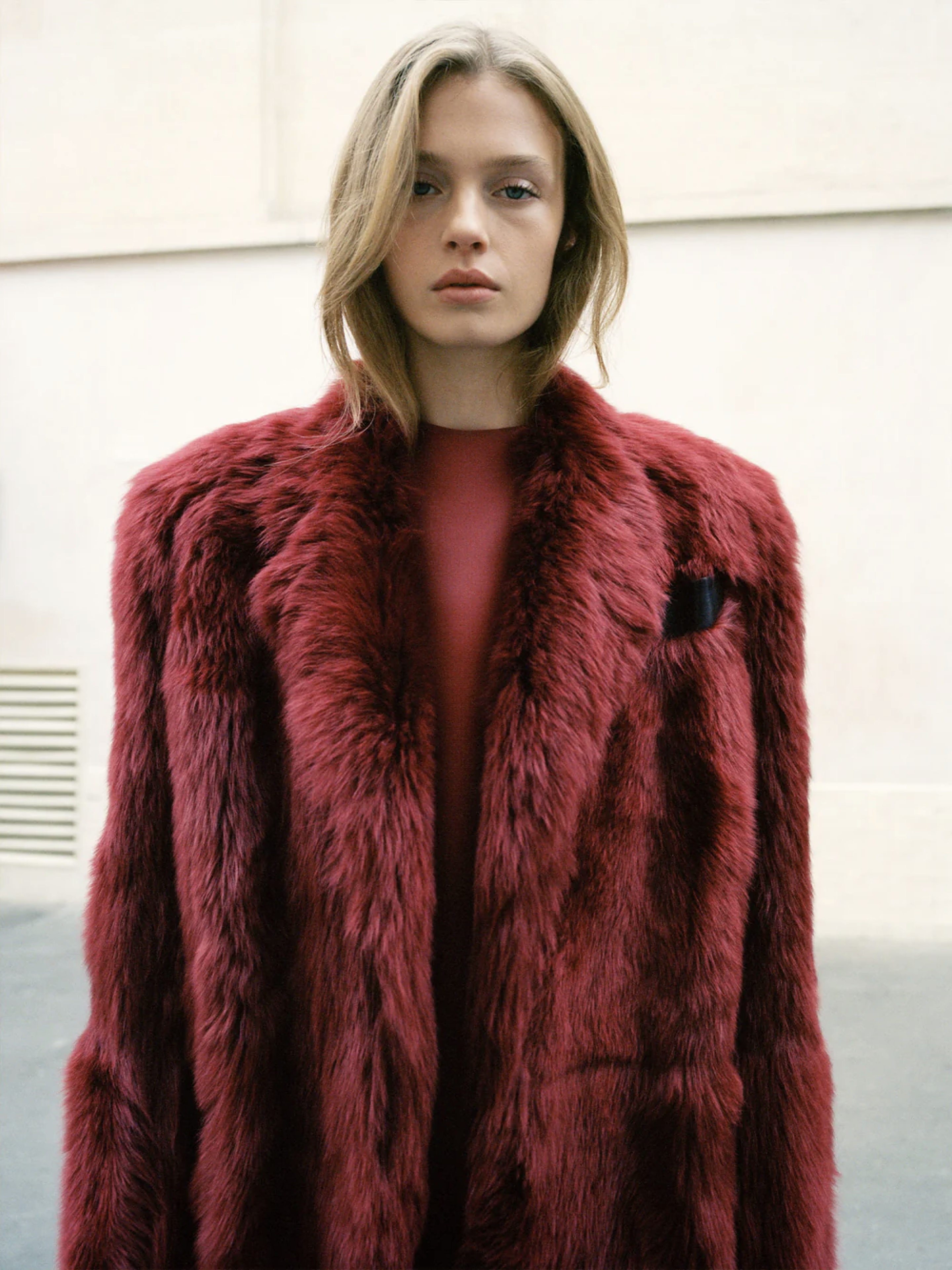 Woman in Khaite red fur coat
