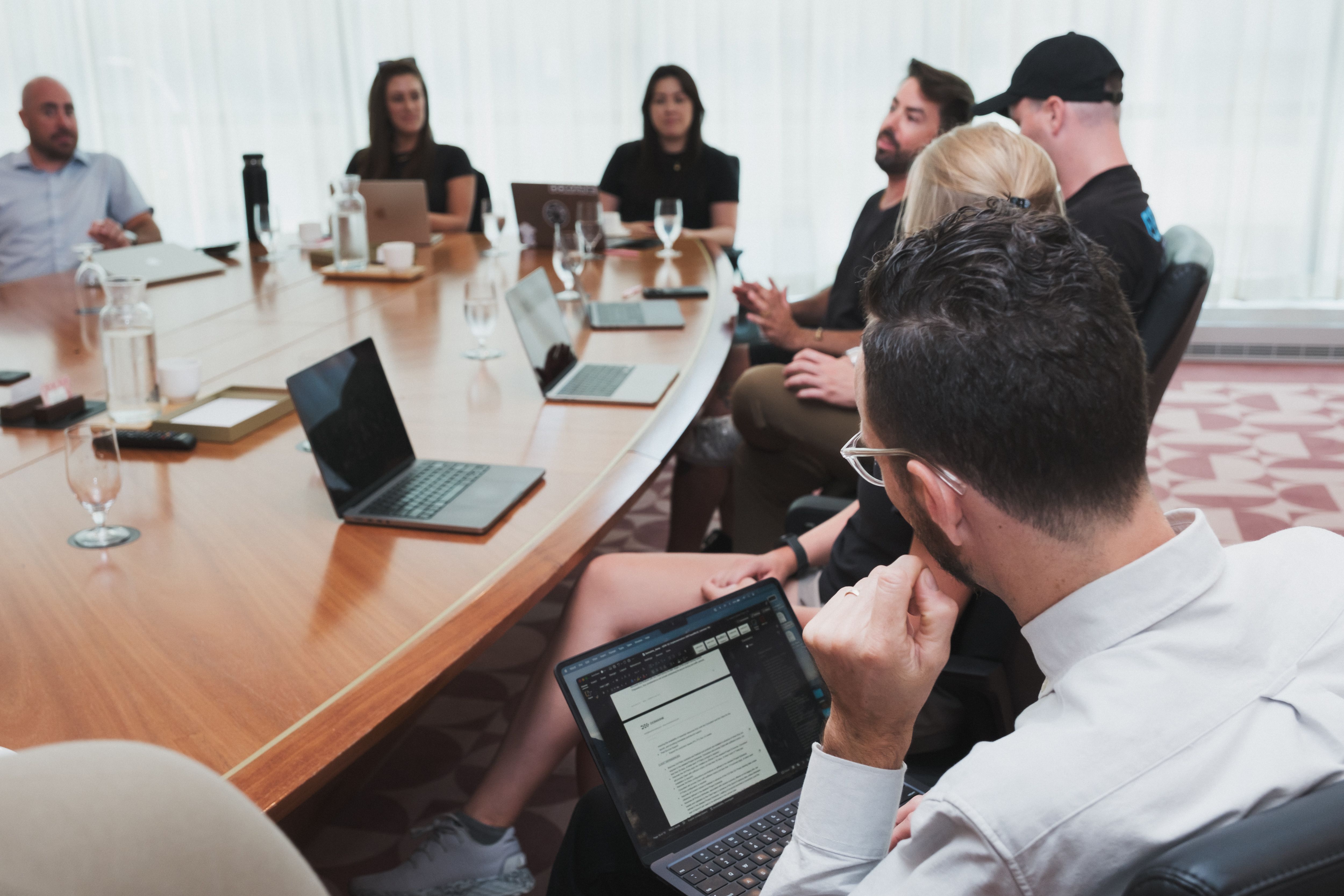 Team members all sitting at board room table