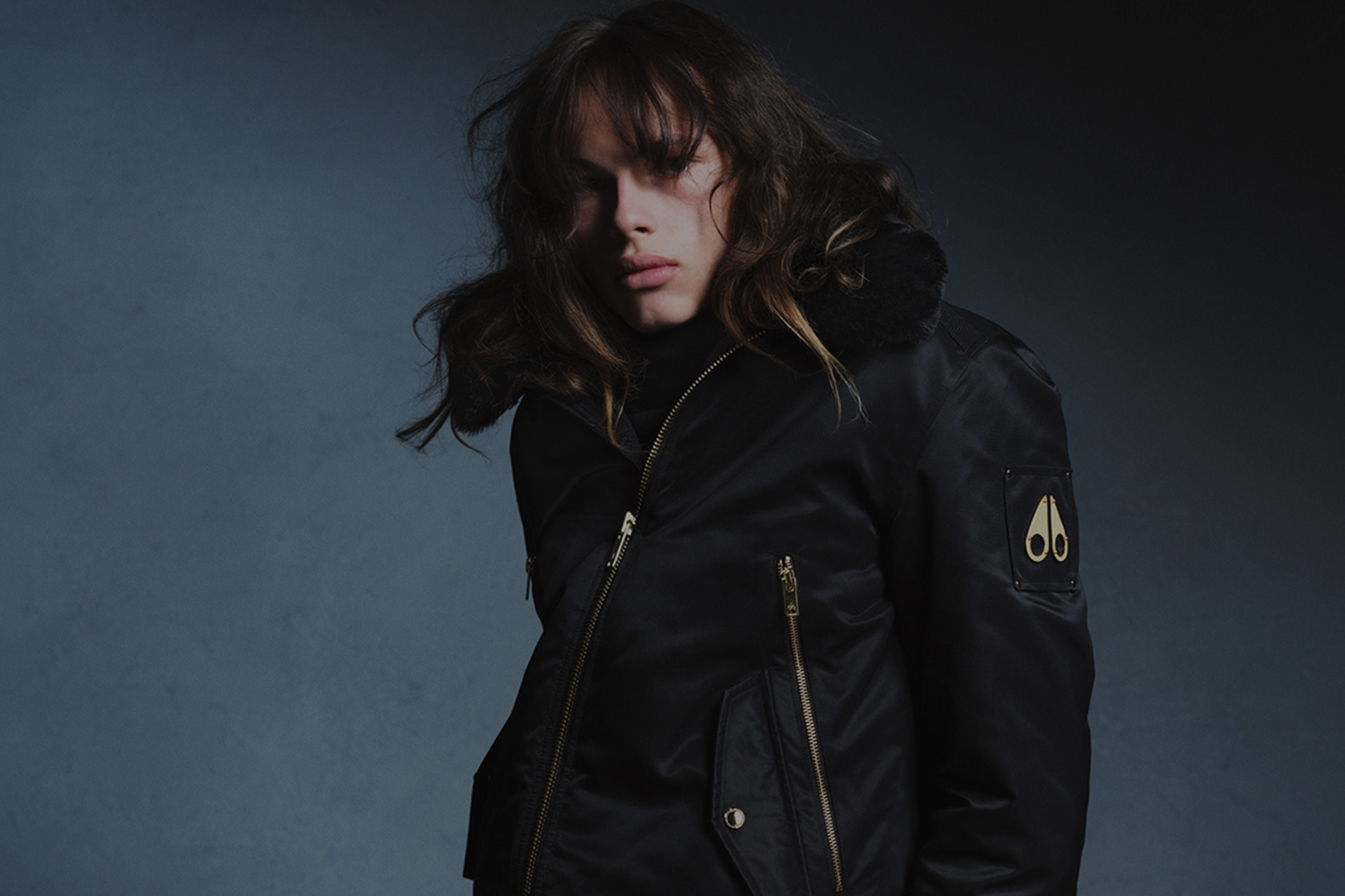 Model wearing black jacket from Moose Knuckles