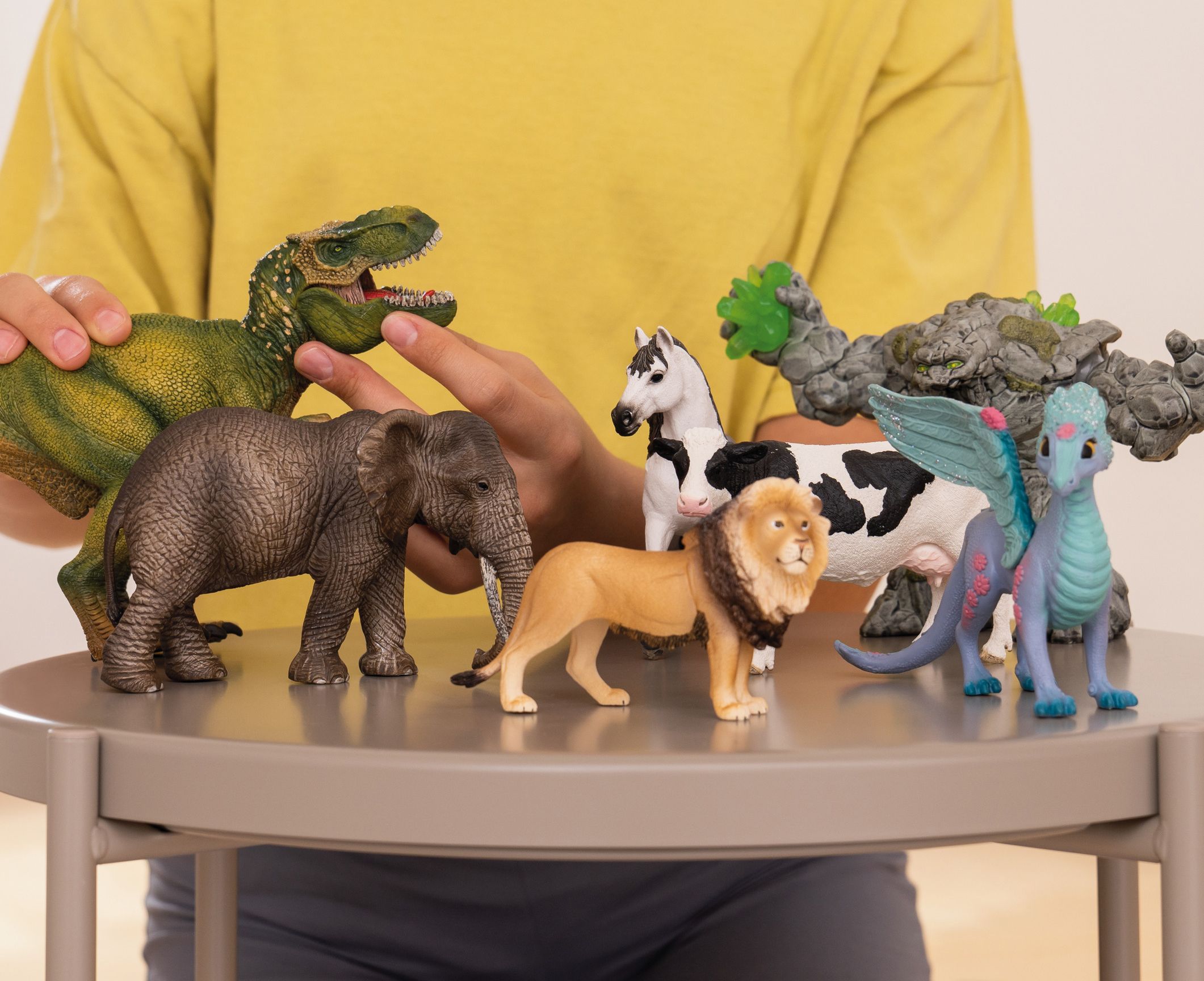 Child playing with various Schleich figurines 