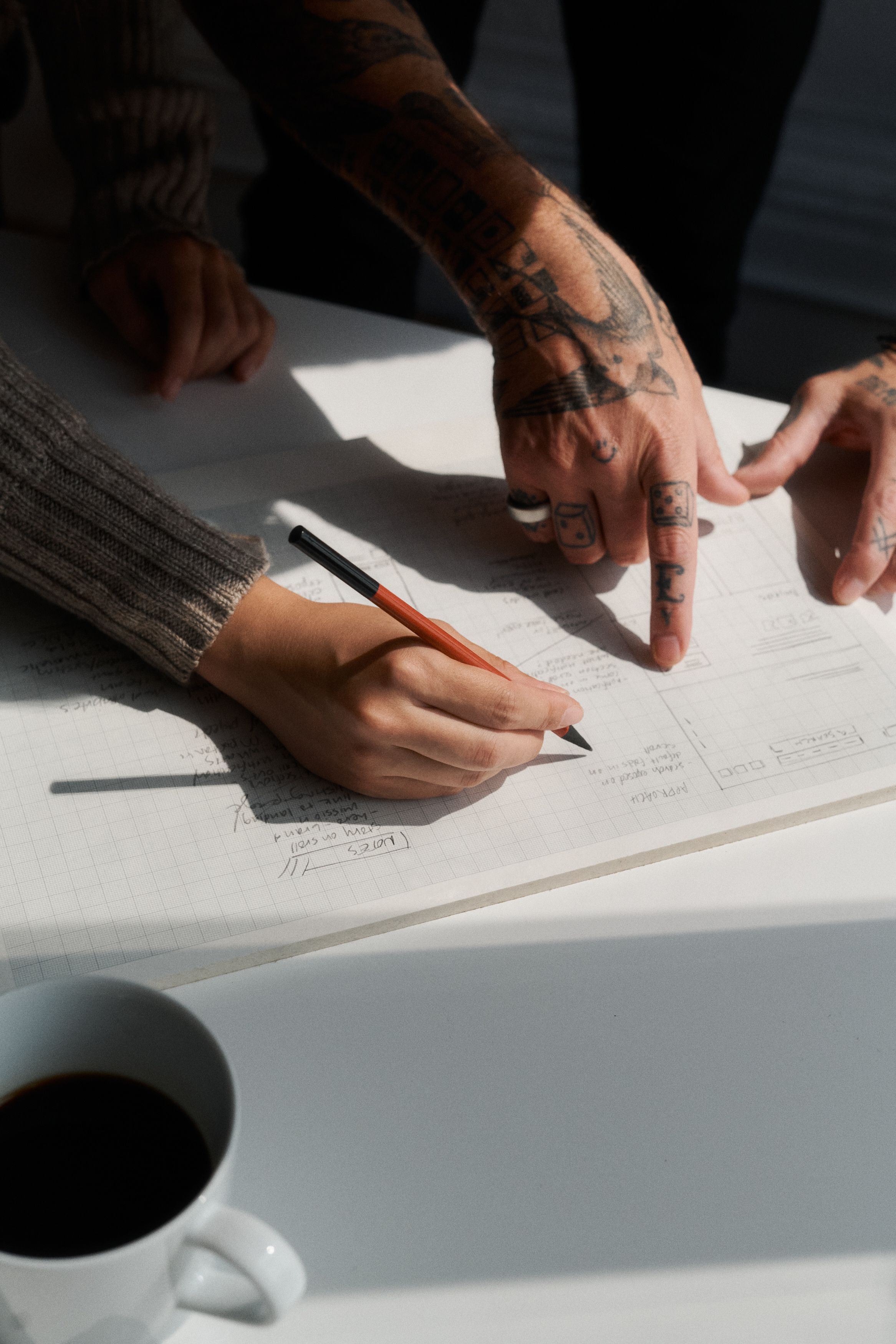 Hands pointing at planning document