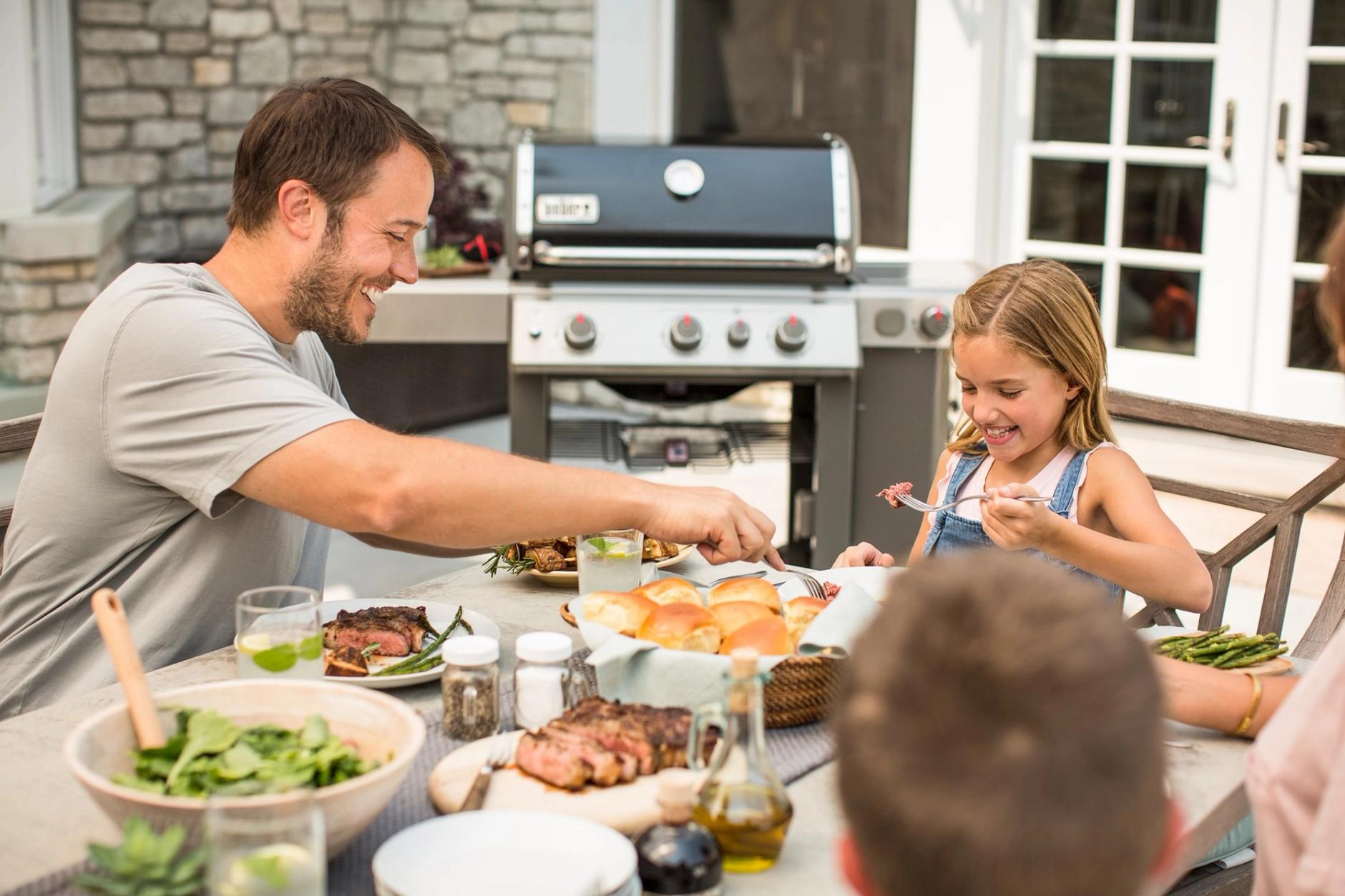 Family enjoying food on a patio