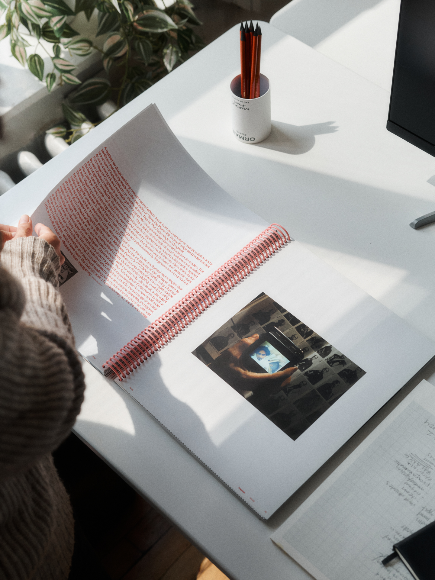 person reading a magazine about design 