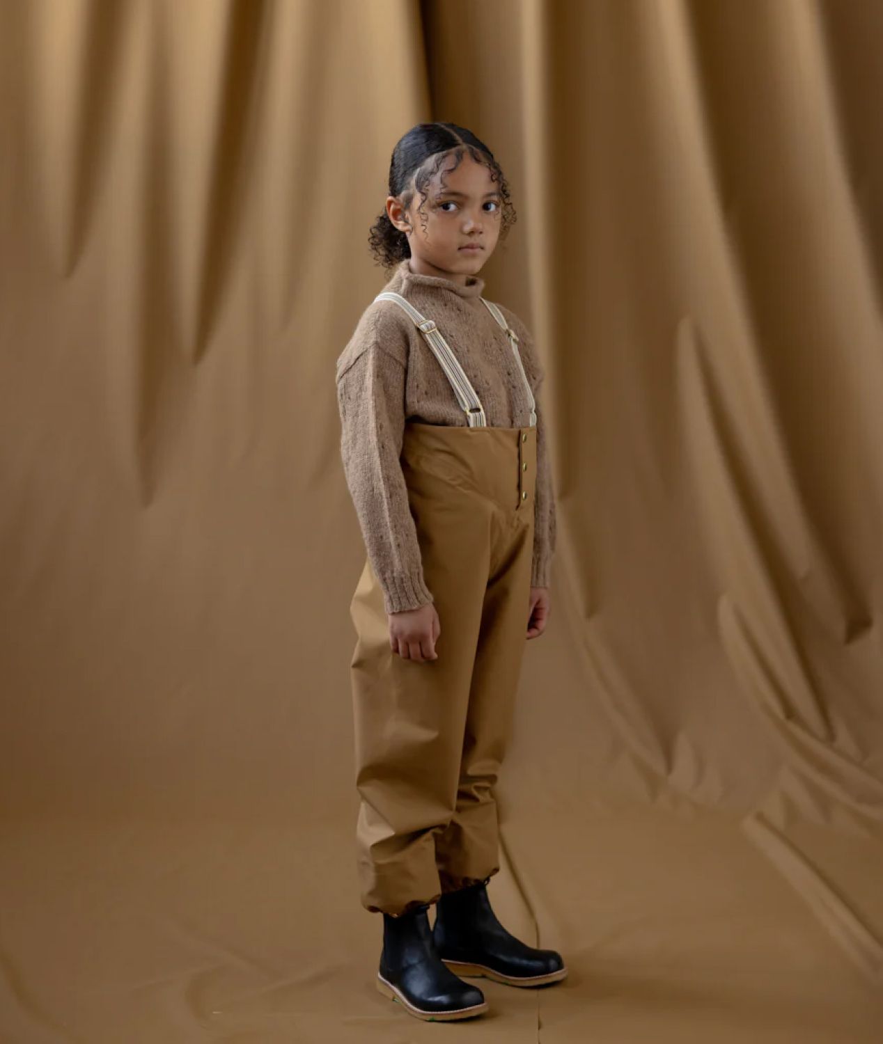 Child wearing Faire Child coveralls