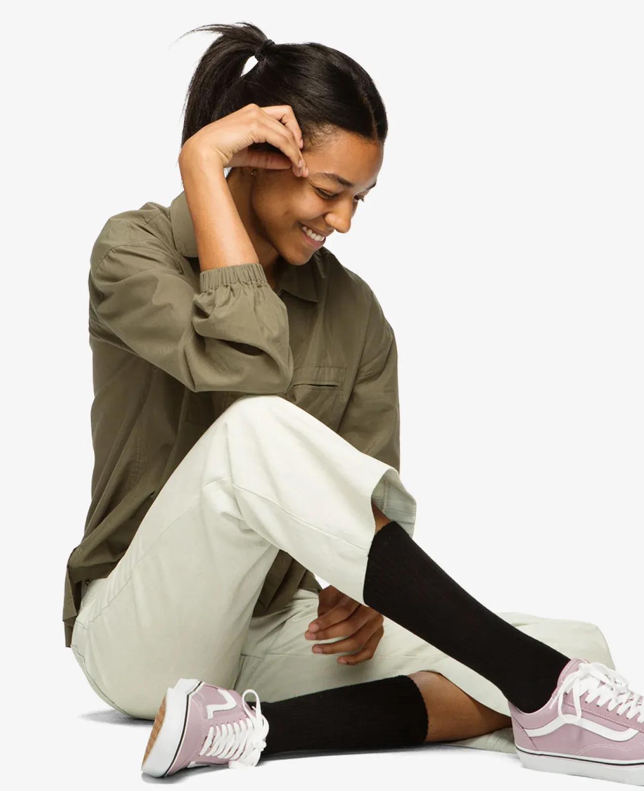 Woman poses sitting with her Bombas socks on