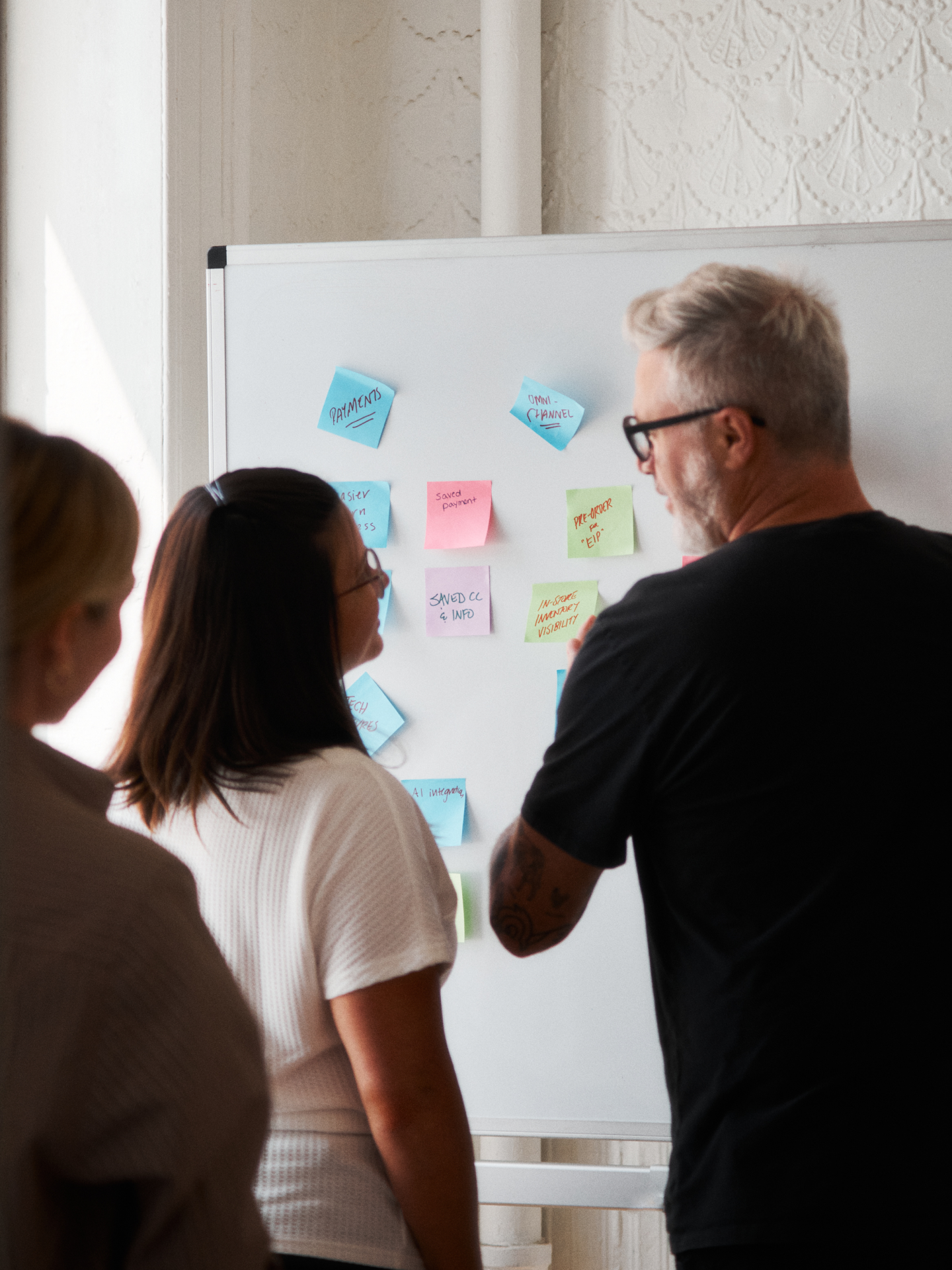 Marko, Stacy, and Lenora working at a whiteboard