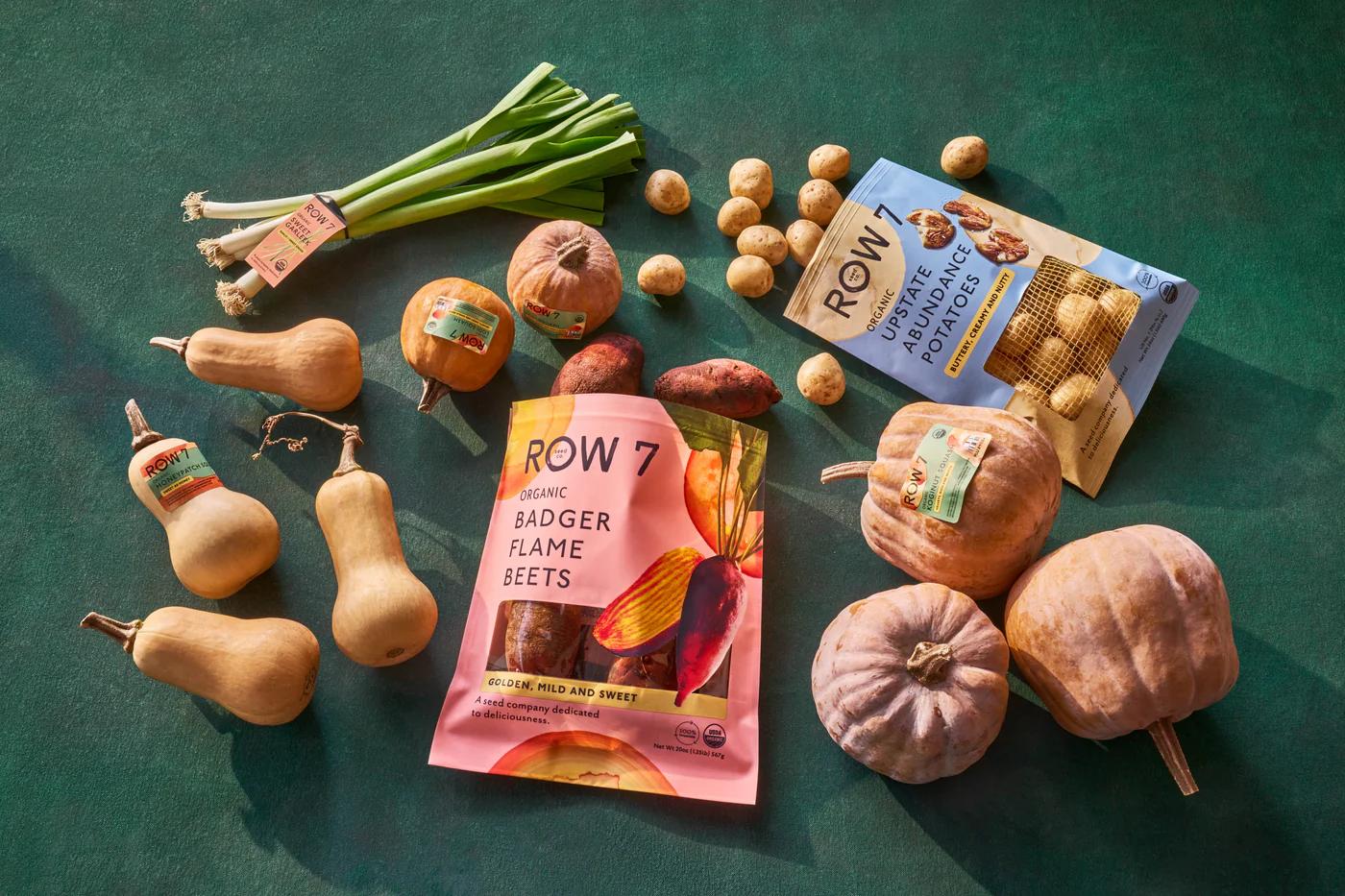 Vegetables and seeds strewn out on green table