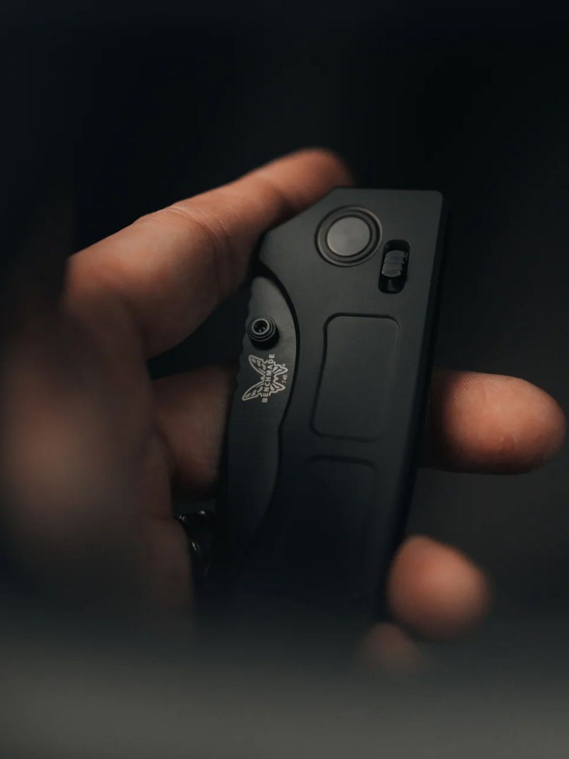 Hand holding a closed Benchmade knife