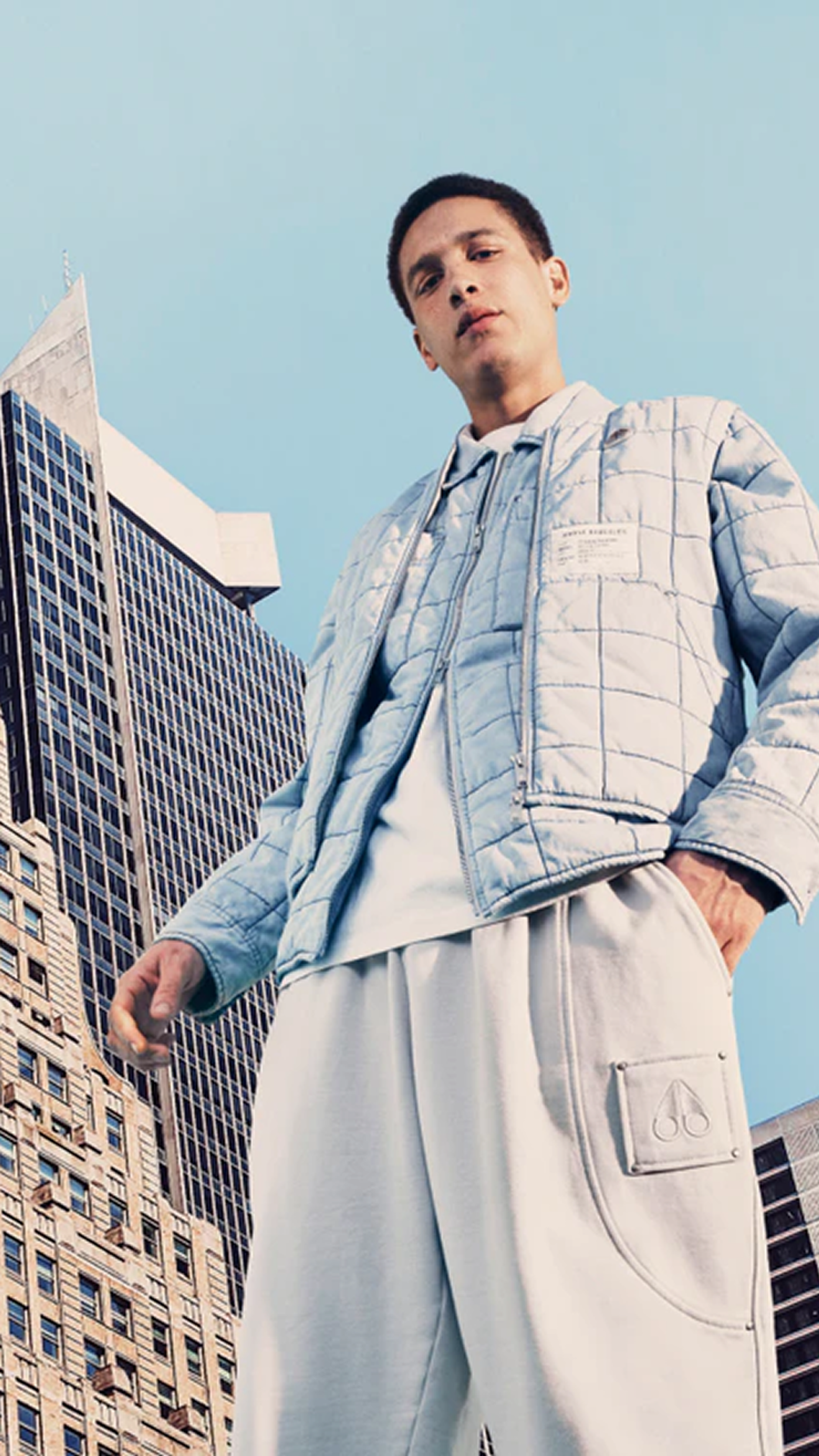 Guy modeling in light outfit from Moose Knuckles