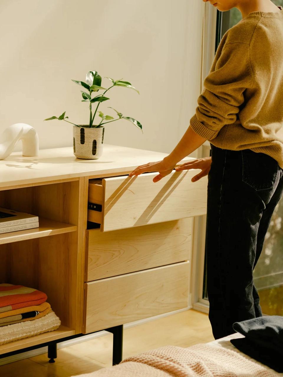 Man sits on Floyd couch while reading.