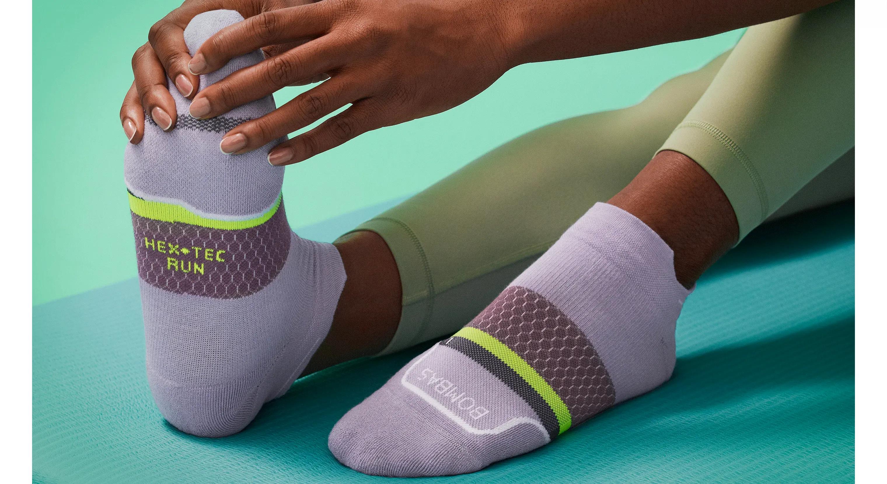 Woman stretching in Bombas socks