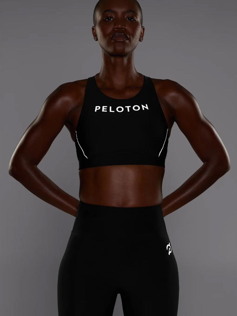Woman wearing Peloton apparel standing on the sidewalk