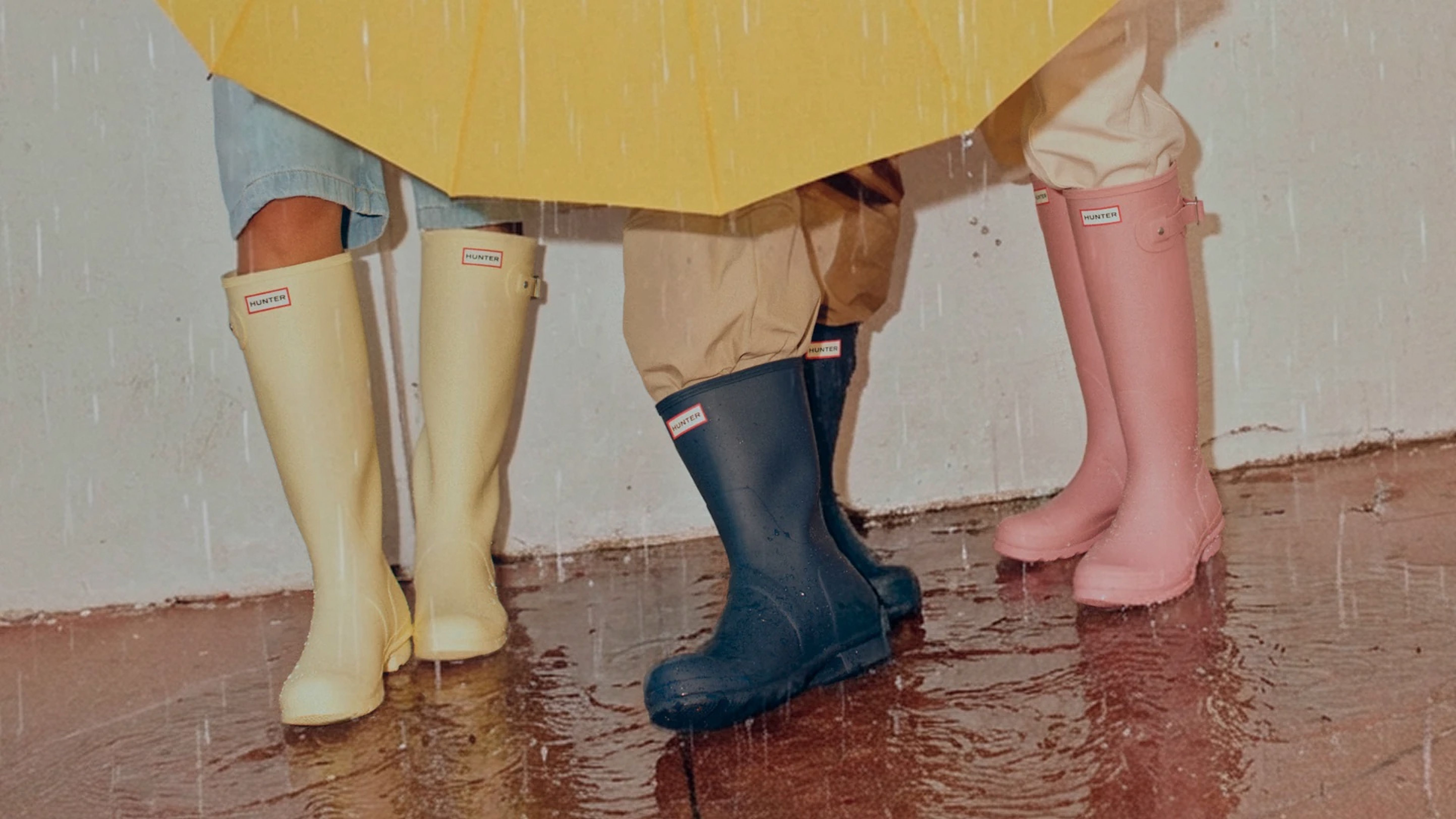 people wearing three colors of hunter rainboots