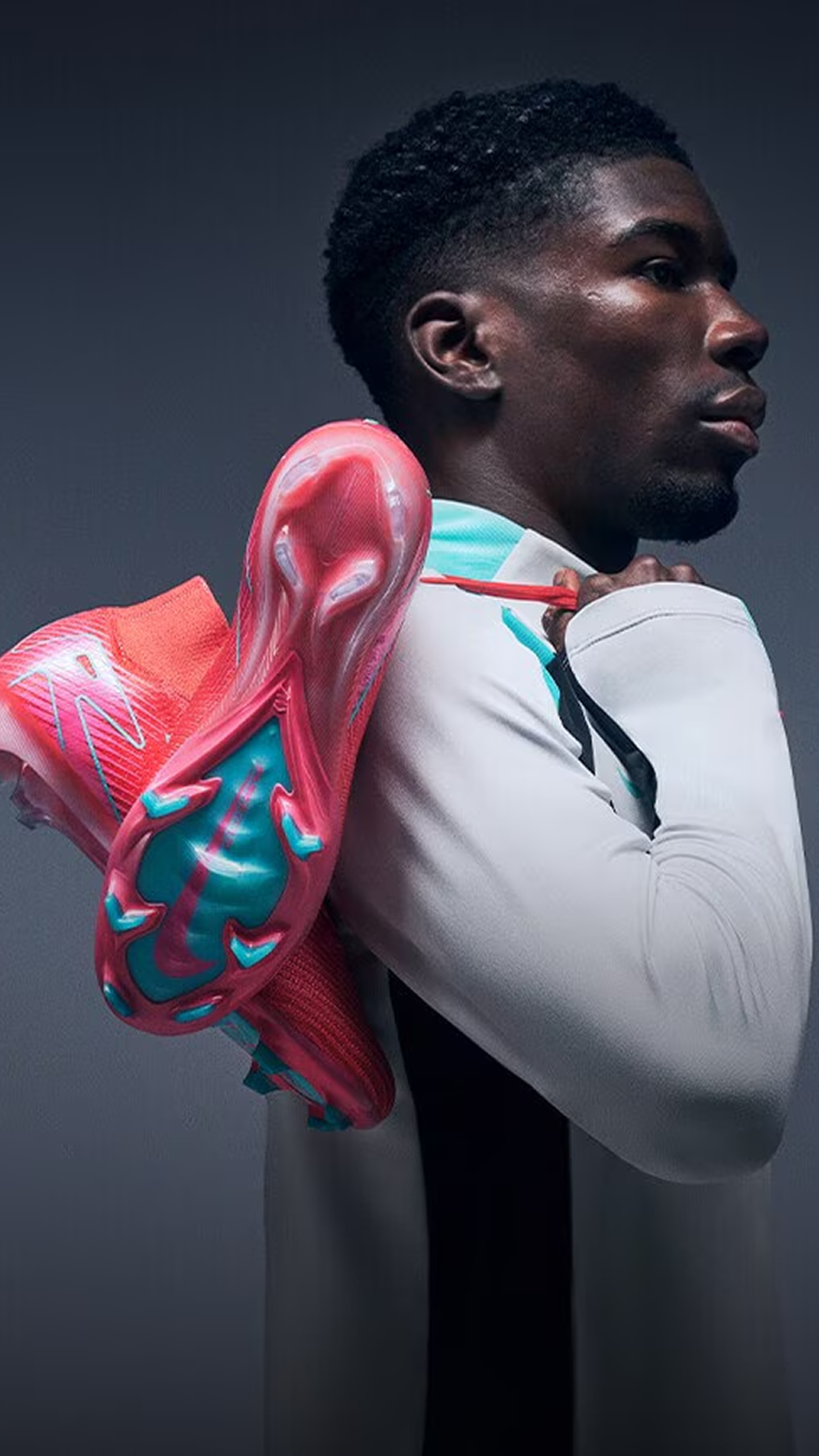Mode with football shoes over shoulders