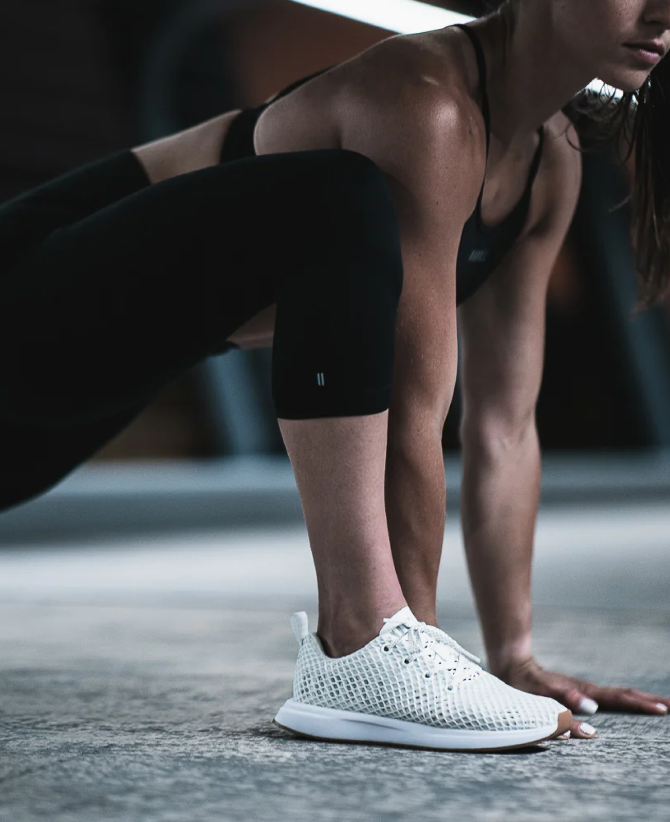 Women stretching in her Nobull sneakers