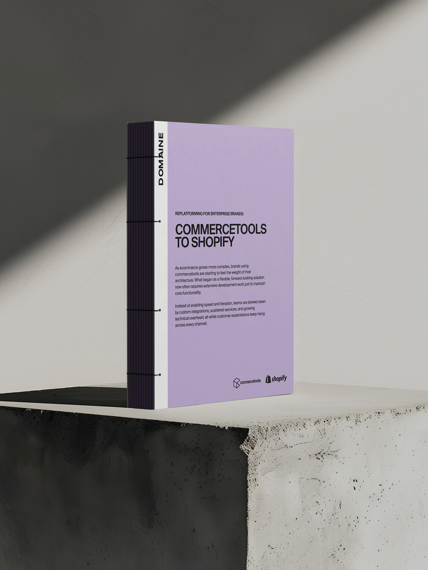 Mockup of commercetools migration guide on a grey background and cement block