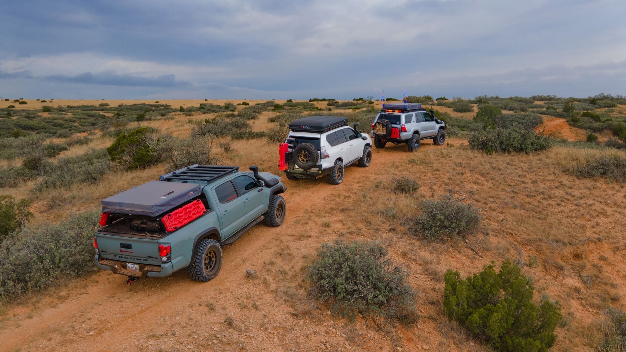 Vans going over a hill
