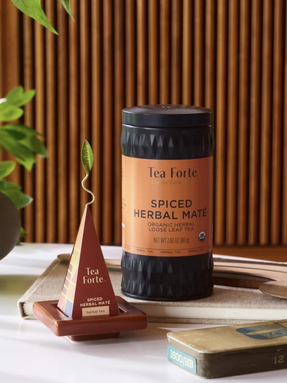 Top-down view of a tea kettle and 2 tea cups on a table