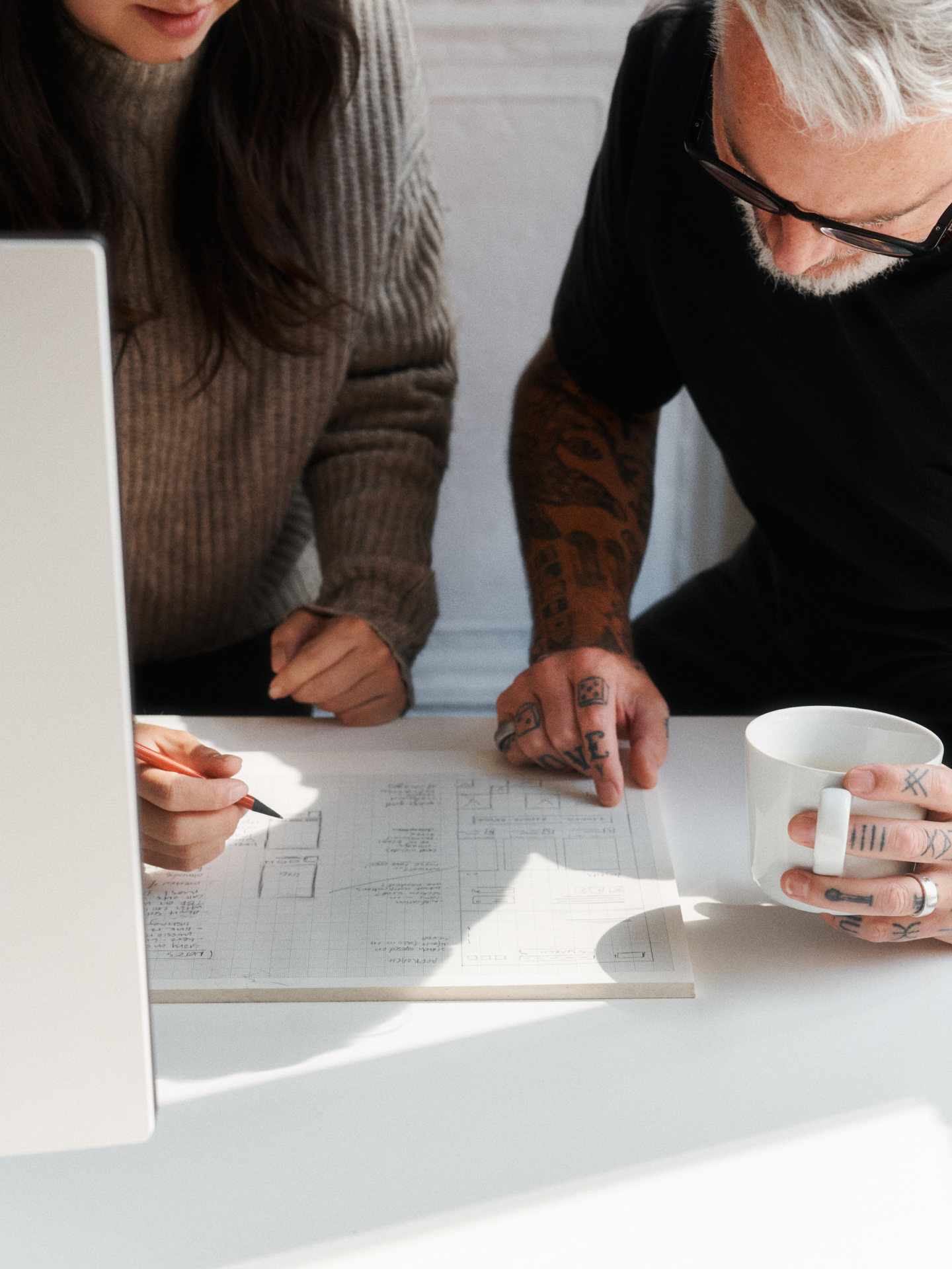 employees looking at notes on desk