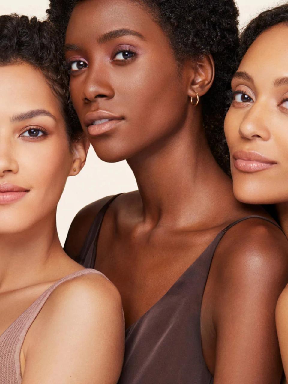 3 models with glowing skin posing