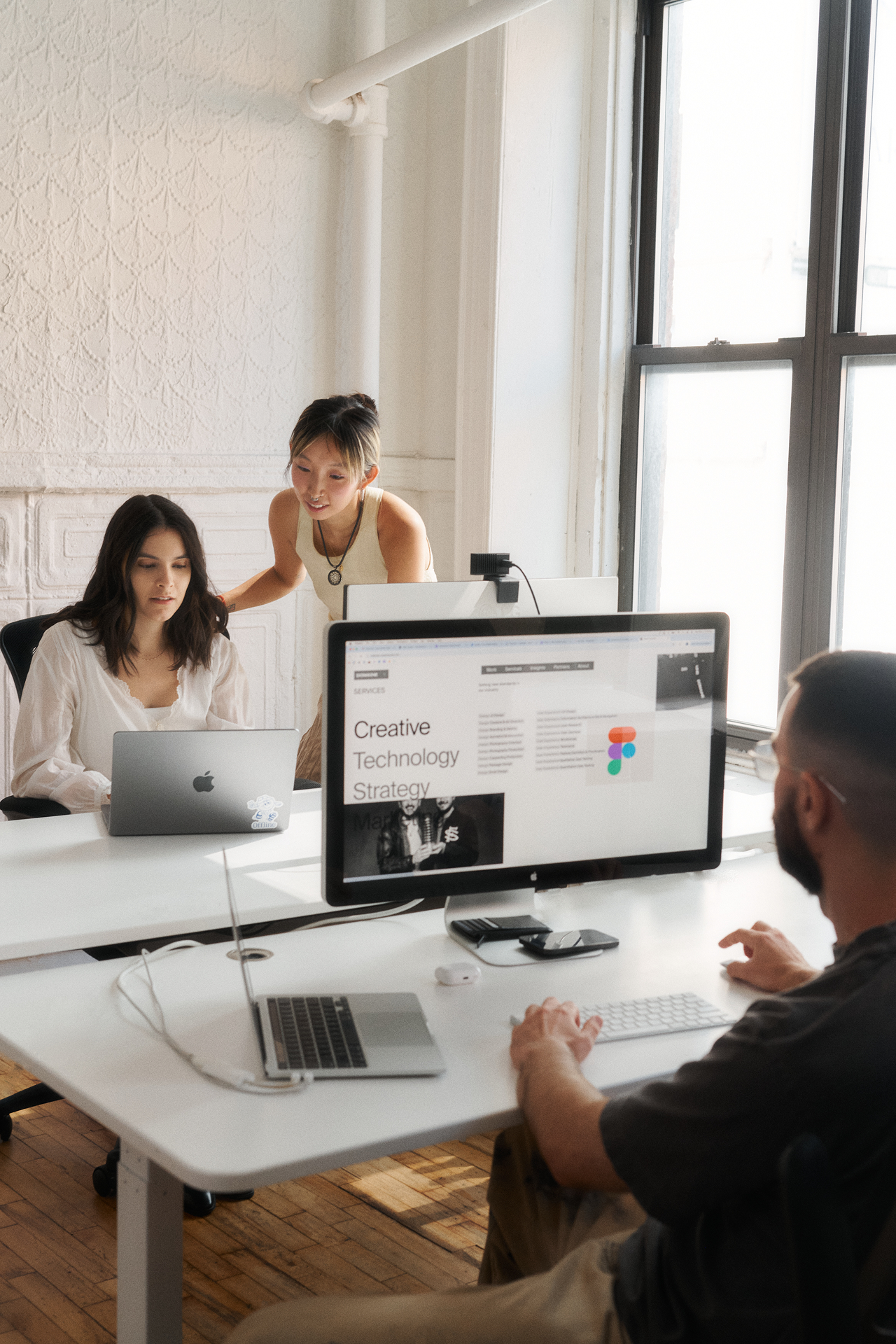 employees collaborating at a desktop
