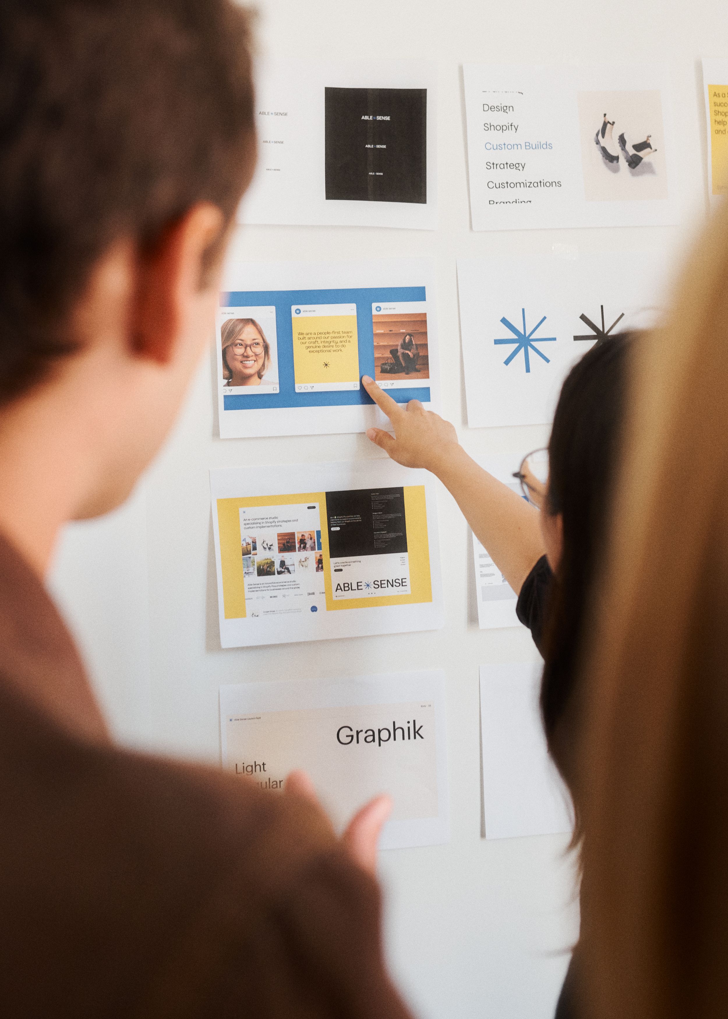 Team members pointing at graphics on a board