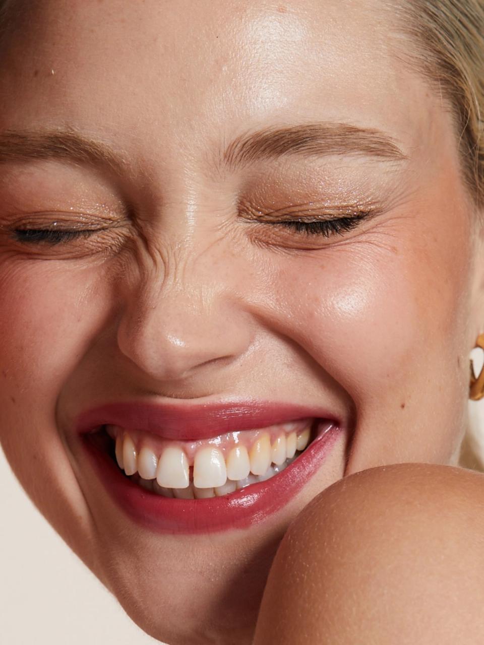 Four smiling women wearing Lip Lab lipstick