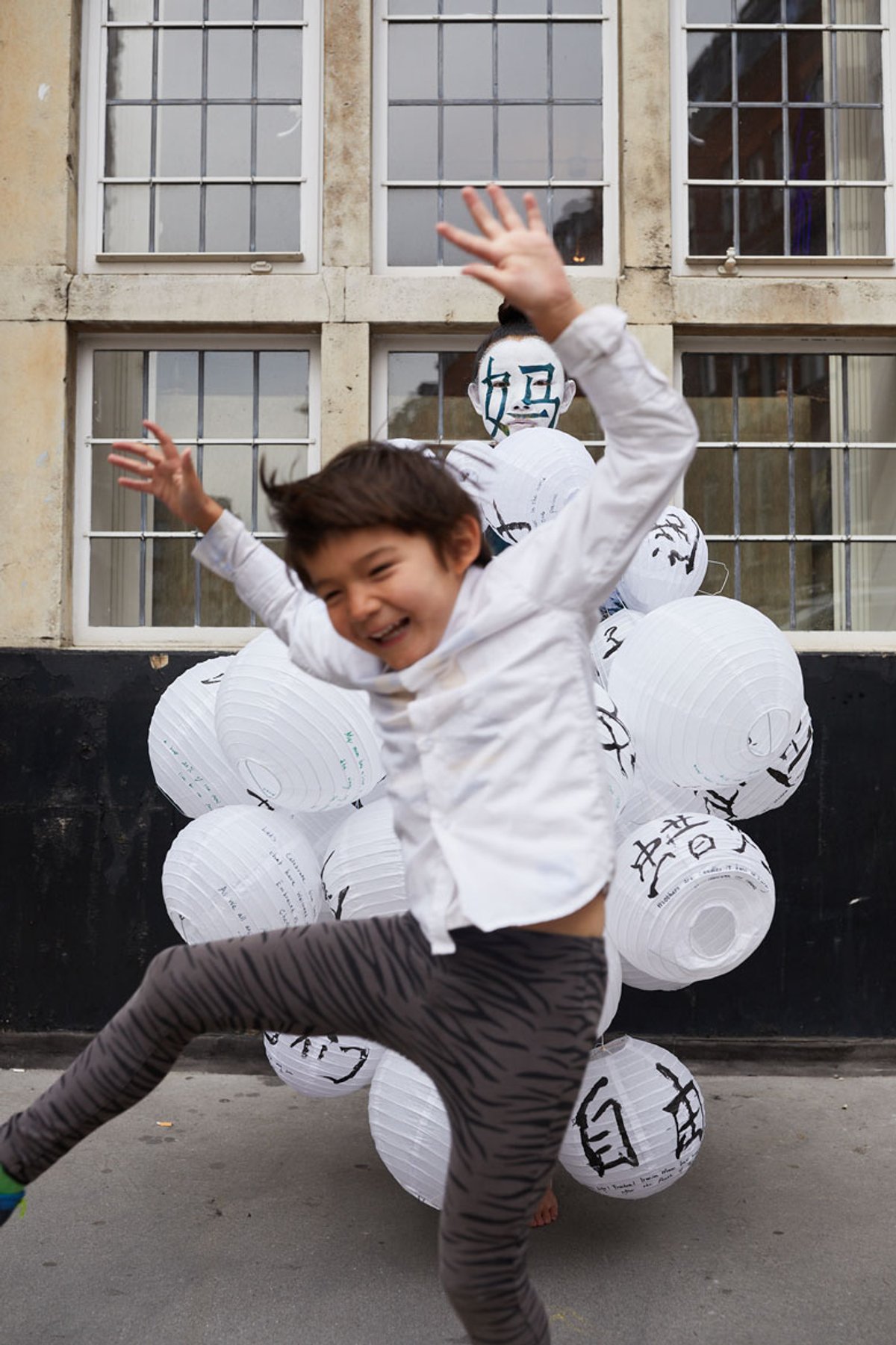 A child joins in with Echo Morgan's performance Woman 女 + Horse 马 = Mother 妈 at TJ Boulting during Love, Celebration and the Road Ahead, a three-day festival to mark the launch of Hettie Judah's book Photo: © Jamie Baker