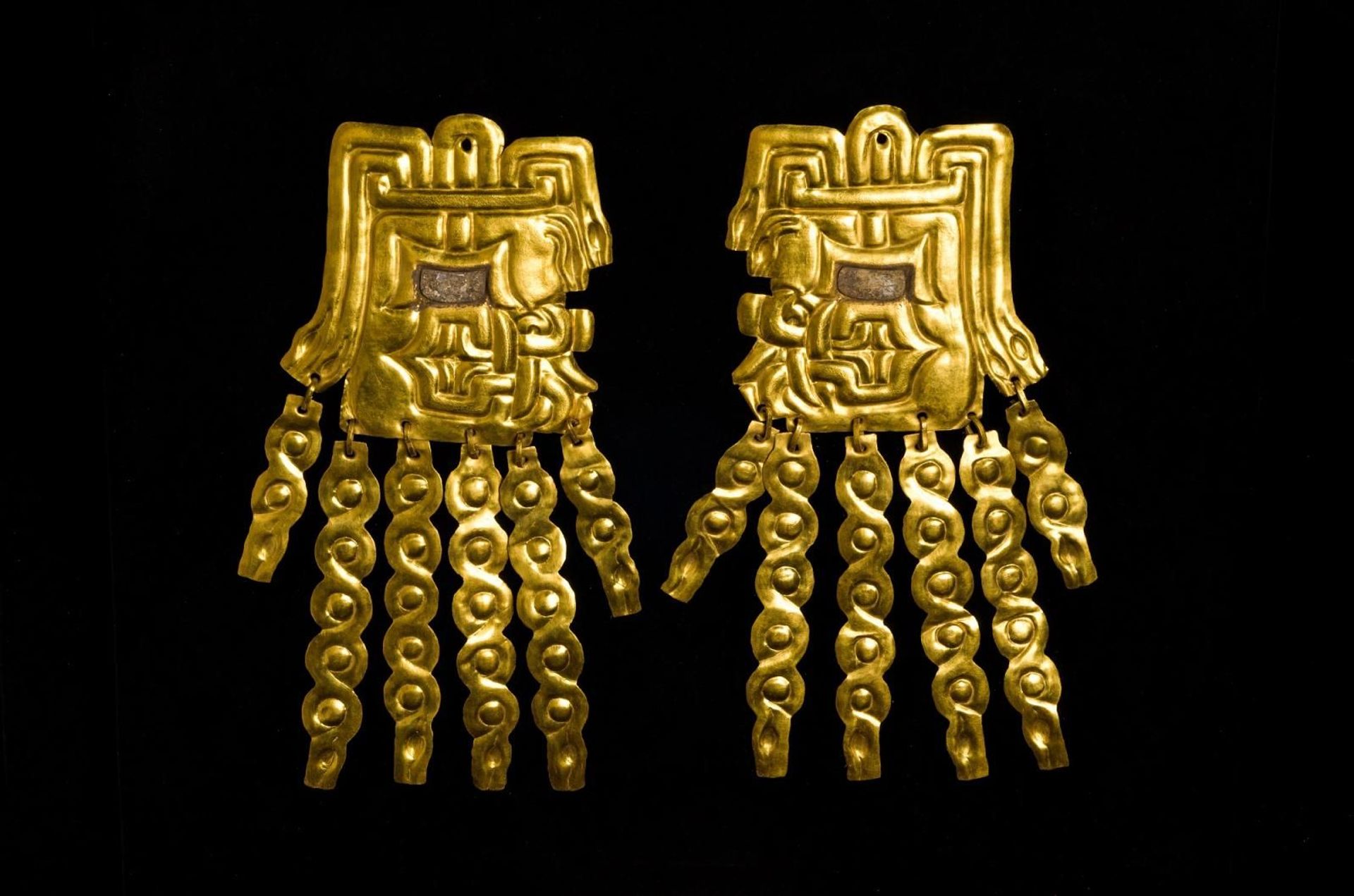 Gold alloy and shell ear plates with feline features, Peru, 800 BCE to 550 BCE (Photo: Alvaro Uematsu/The British Museum)