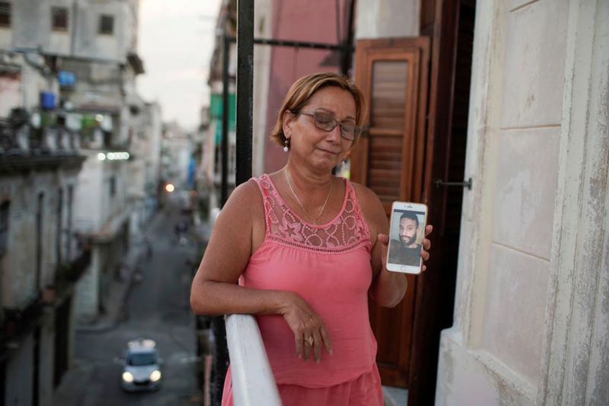 Raisa Gonzalez shows a picture of her son Anyelo Troya Gonzalez, an artist arrested after protests in Havana REUTERS/Alexandre Meneghini