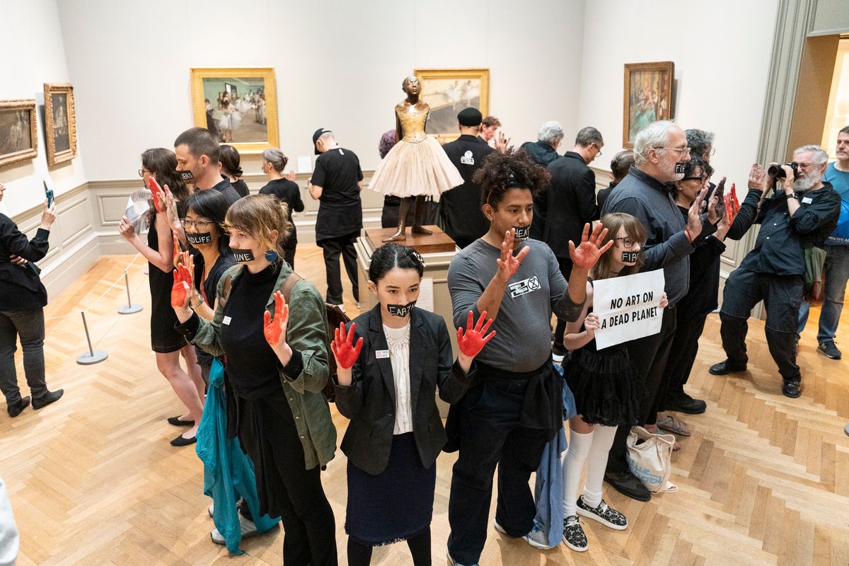 Activists demonstrating in front of artwork by French Impressionist Edgar Degas at the Metropolitan Museum of Art on 24 June. Courtesy Graham MacIndoe and Extinction Rebellion