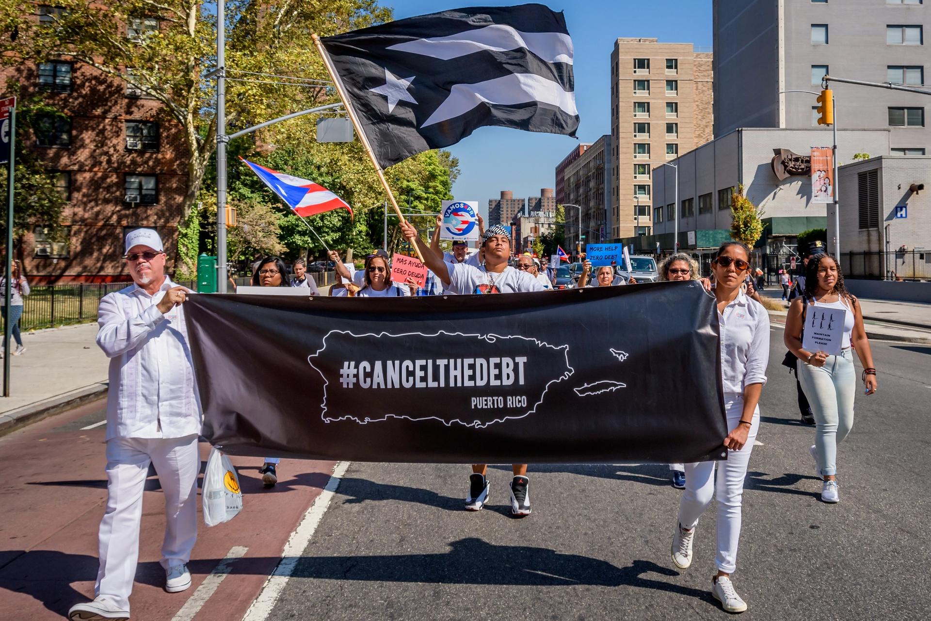 Hundreds of Puerto Ricans dressed in white participated on a silent procession carrying signs and banners through the streets of New York to focus the nation's attention on the island's struggles in the aftermath of Hurricane Maria Photo by Erik McGregor/LightRocket via Getty Images