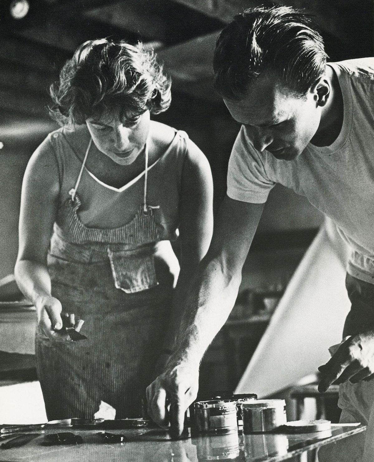 Helen Frankenthaler at work with an unidentified man in her studio in West Islip, New York, in 1964 Science History Images / Alamy Stock Photo