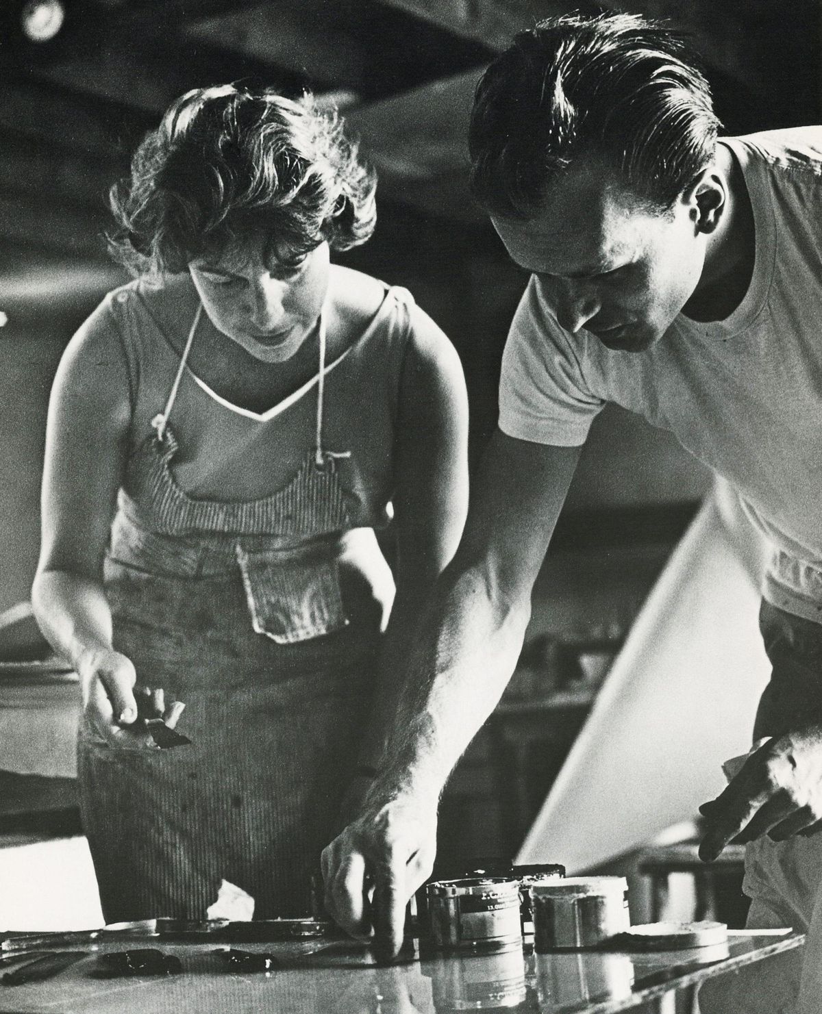 Helen Frankenthaler at work with an unidentified man in her studio in West Islip, New York, 1964 Science History Images / Alamy Stock Photo